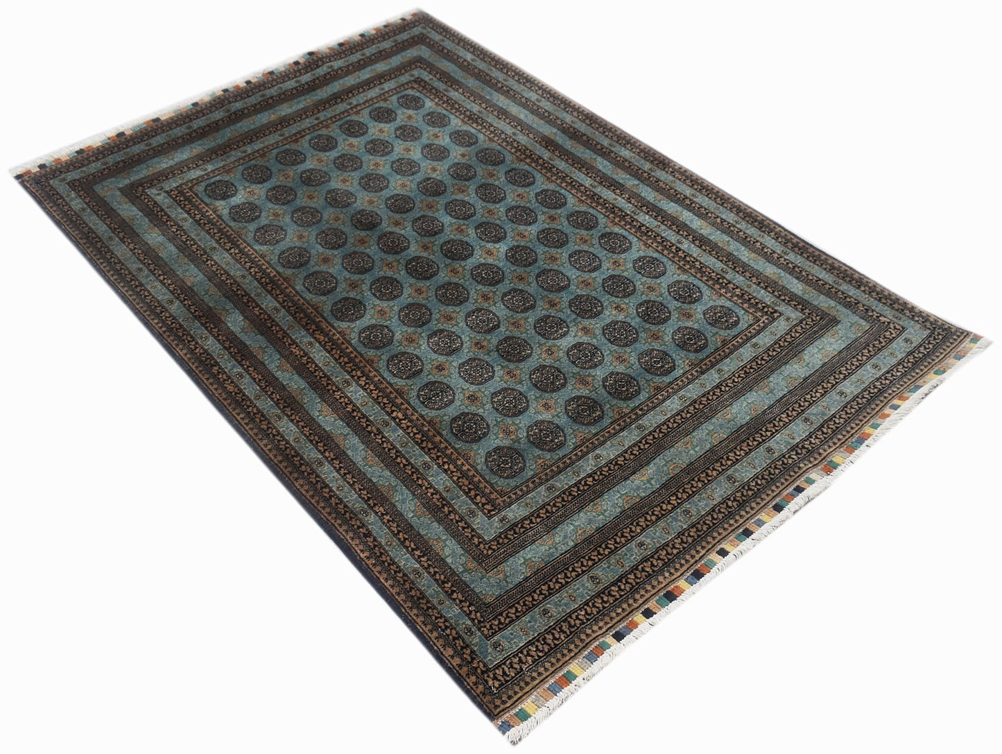 A rectangular vintage Afghan Turkmen rug featuring a repeating dark medallion pattern on teal.