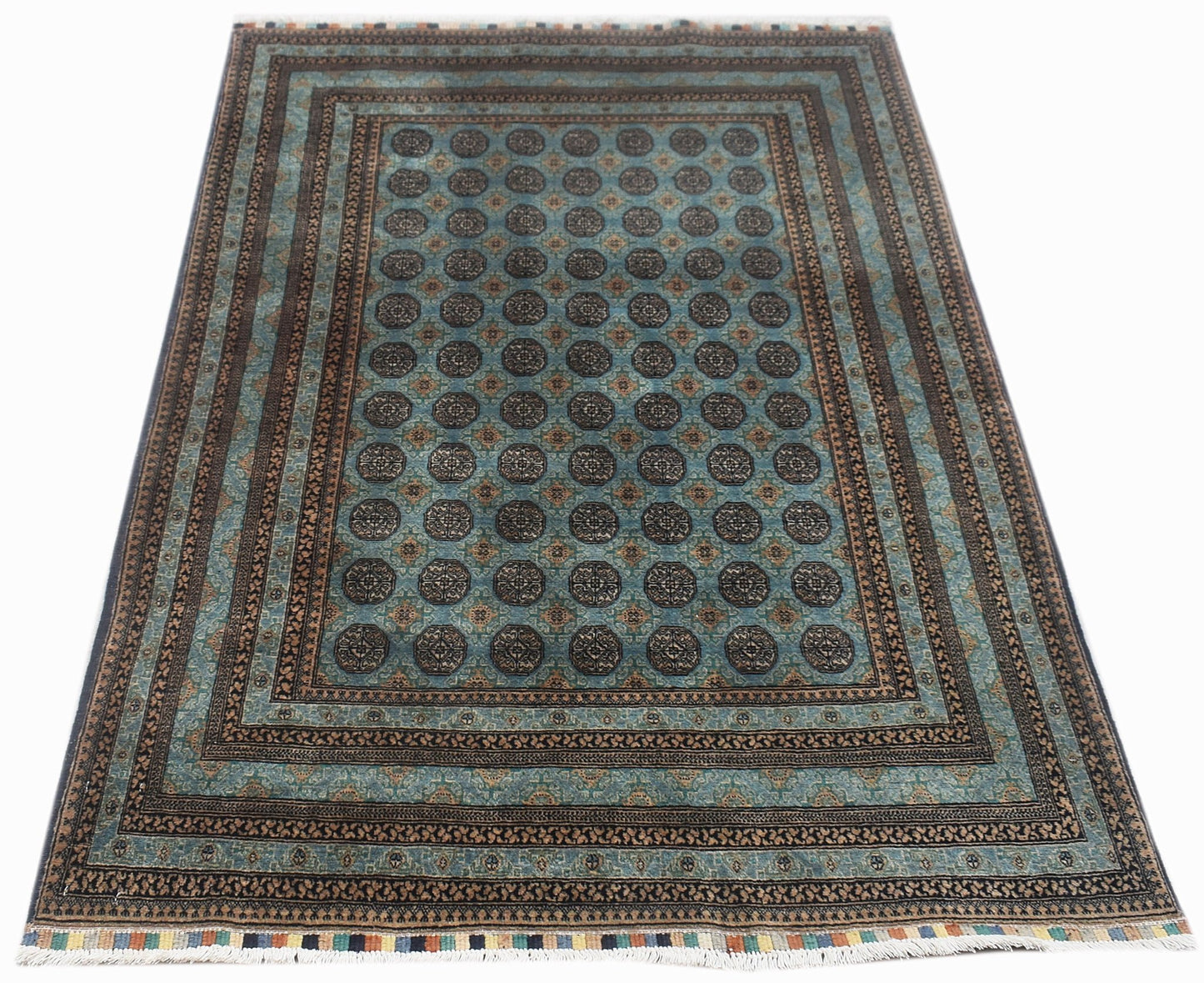 A handmade vintage Afghan Turkmen rug featuring a repeating geometric pattern in blue and brown.
