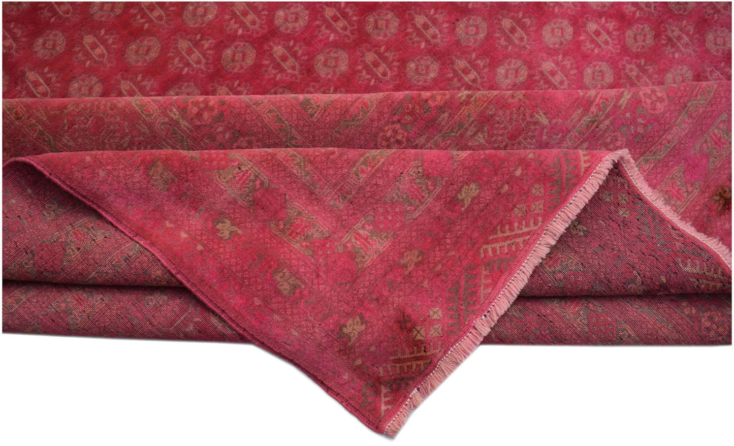A vintage Afghan Turkmen rug in shades of red with a geometric pattern and a fringed edge.