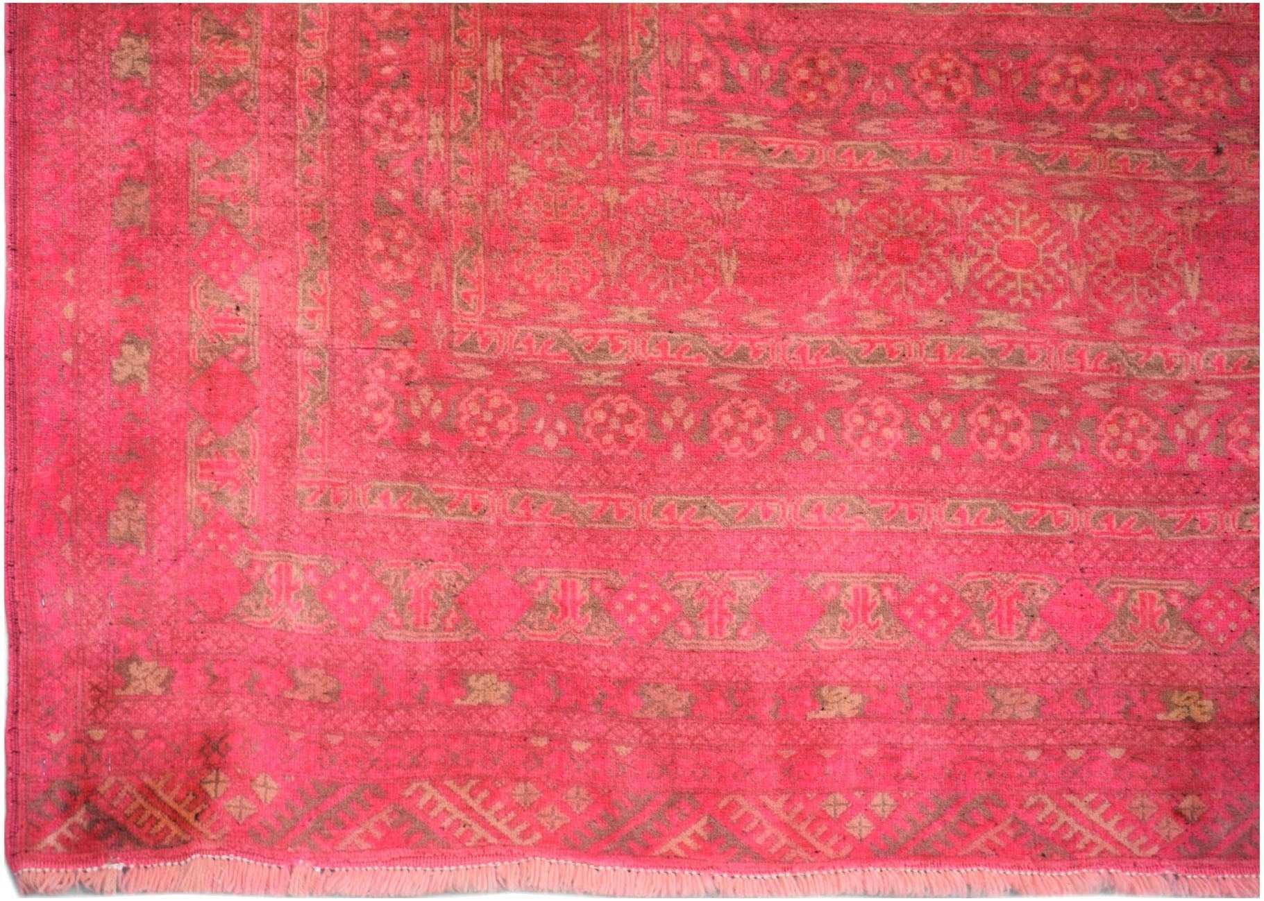 A vintage handmade Afghan Turkmen rug featuring intricate geometric patterns in shades of pink.