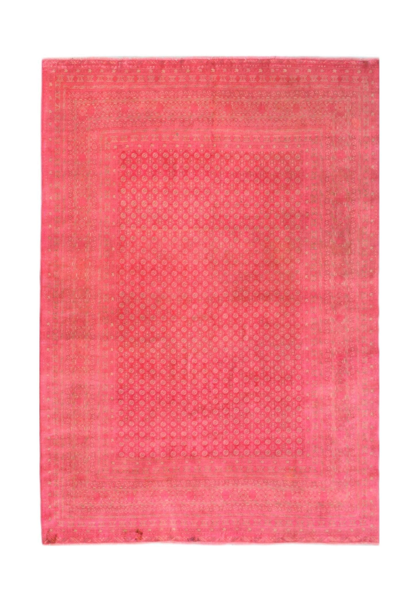 A rectangular vintage Afghan Turkmen rug featuring a repeating geometric pattern in vibrant pink.