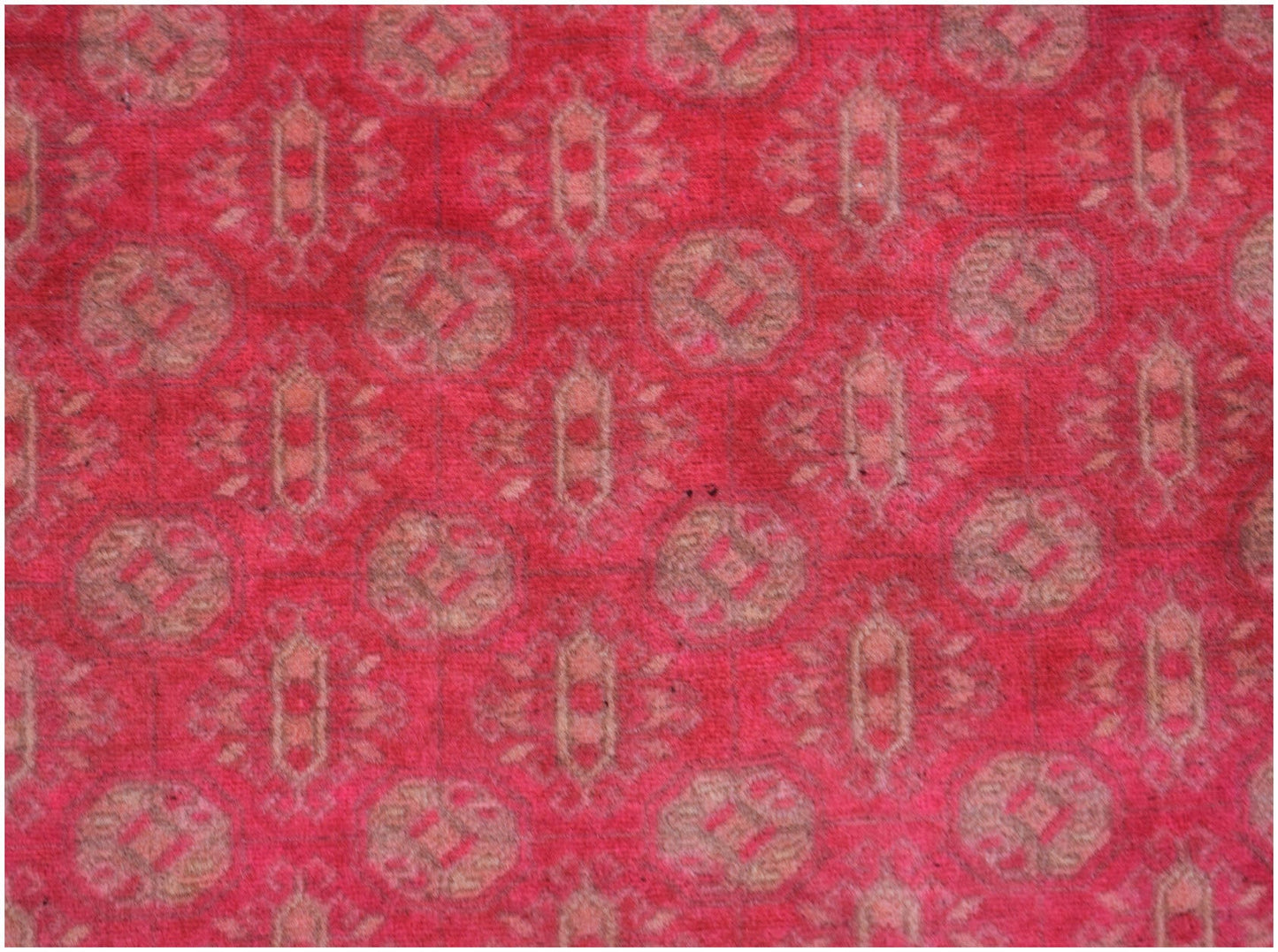 A vintage Afghan Turkmen rug featuring a repeating geometric pattern in shades of red and tan.