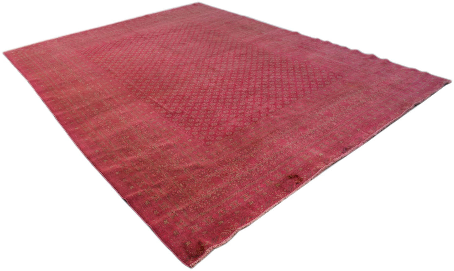 A vintage Afghan Turkmen rug featuring a geometric pattern in shades of red and muted gold.