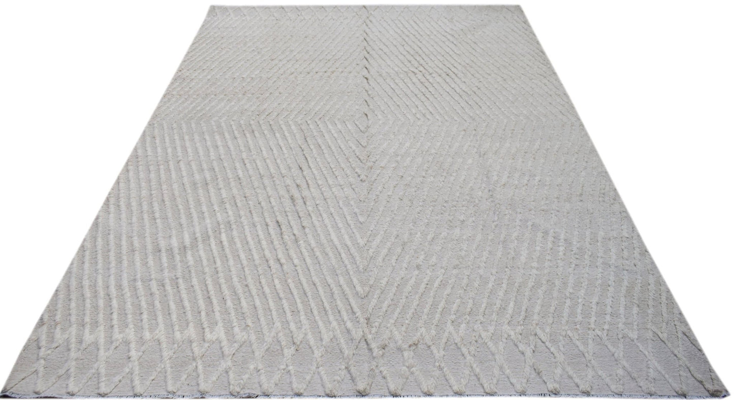 An Afghan Yekta rug featuring a textured, cream-colored geometric diamond pattern.