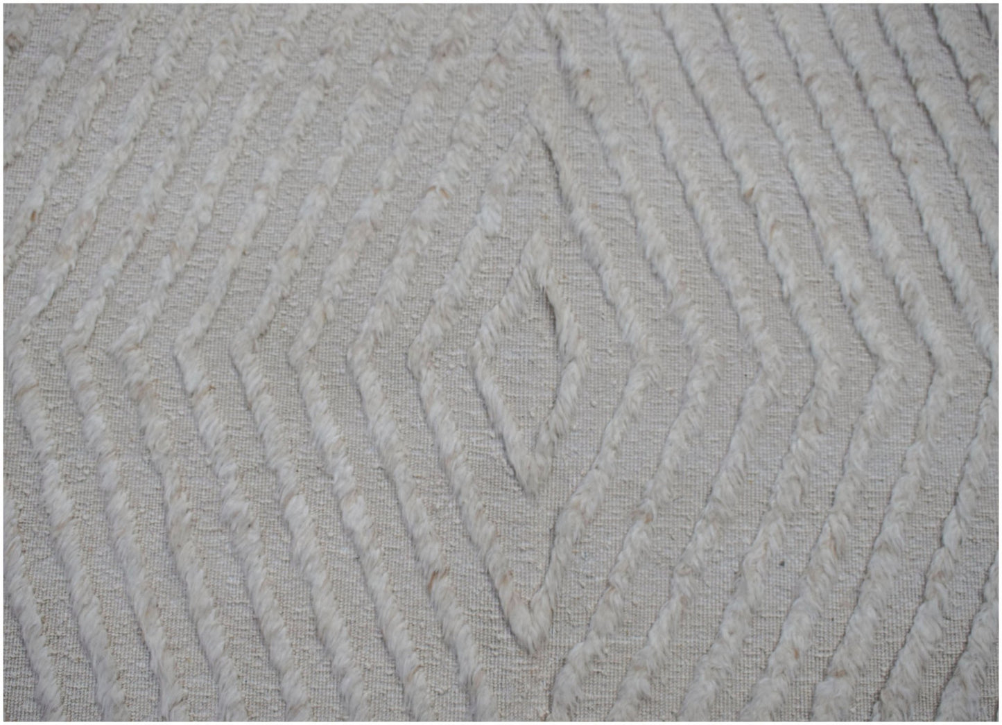 A handmade Afghan Yekta rug featuring a textured, cream-colored diamond pattern.