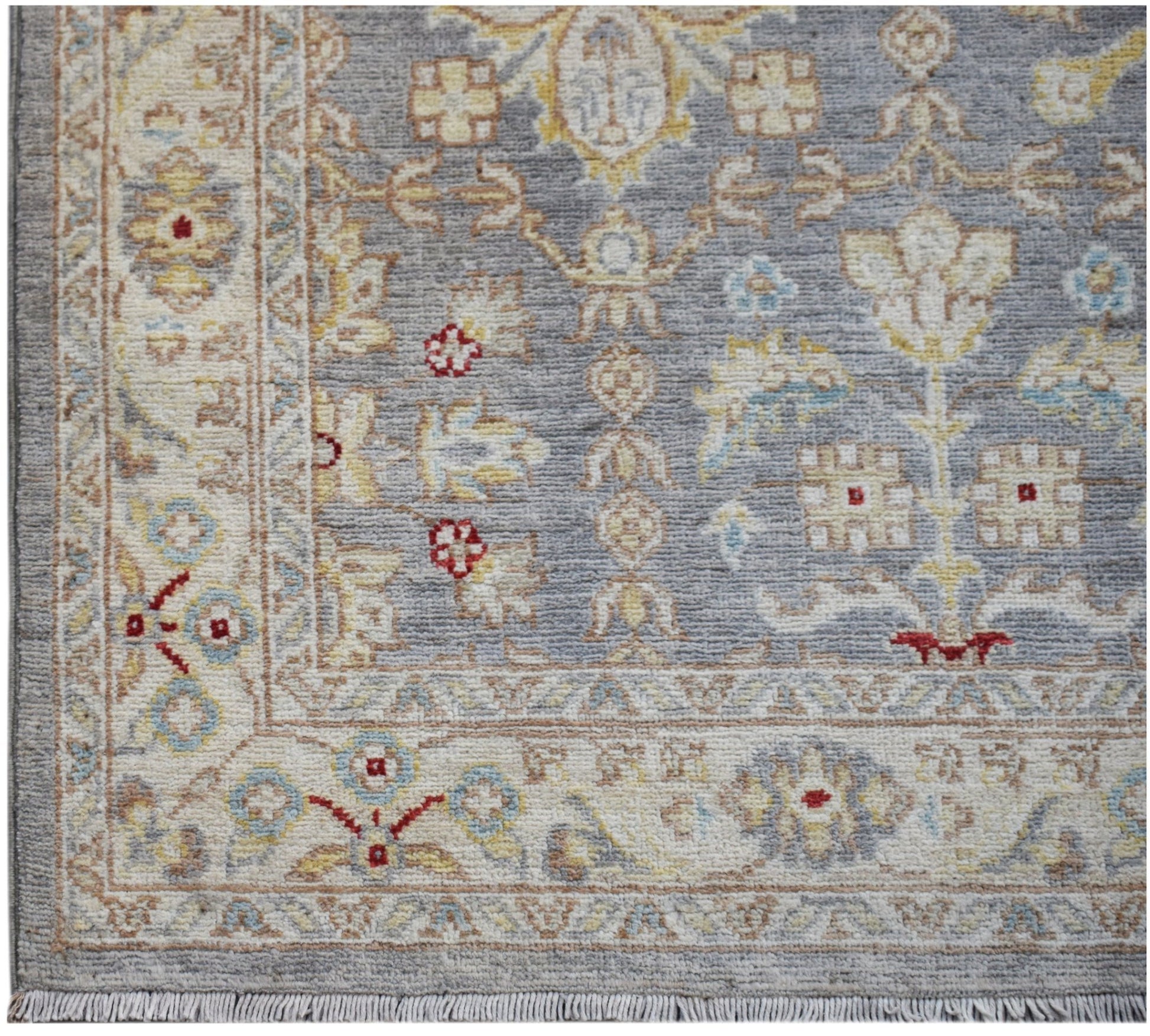 An Afghan Chobi runner featuring a traditional floral pattern in soft grey, beige, and red tones.
