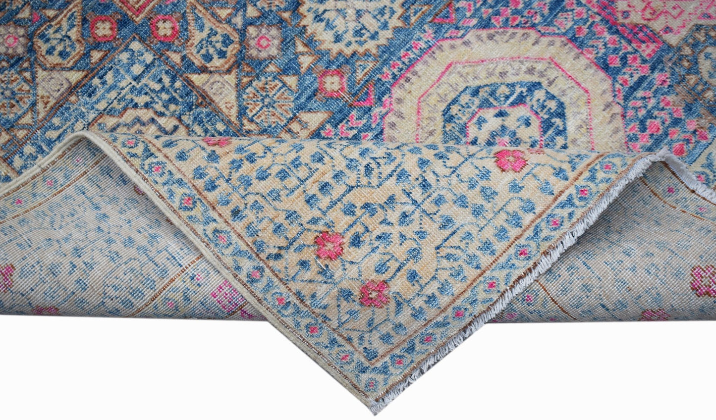 Handwoven Afghan Balkh rug with a blue and cream Mamluk medallion pattern and fringed edges.