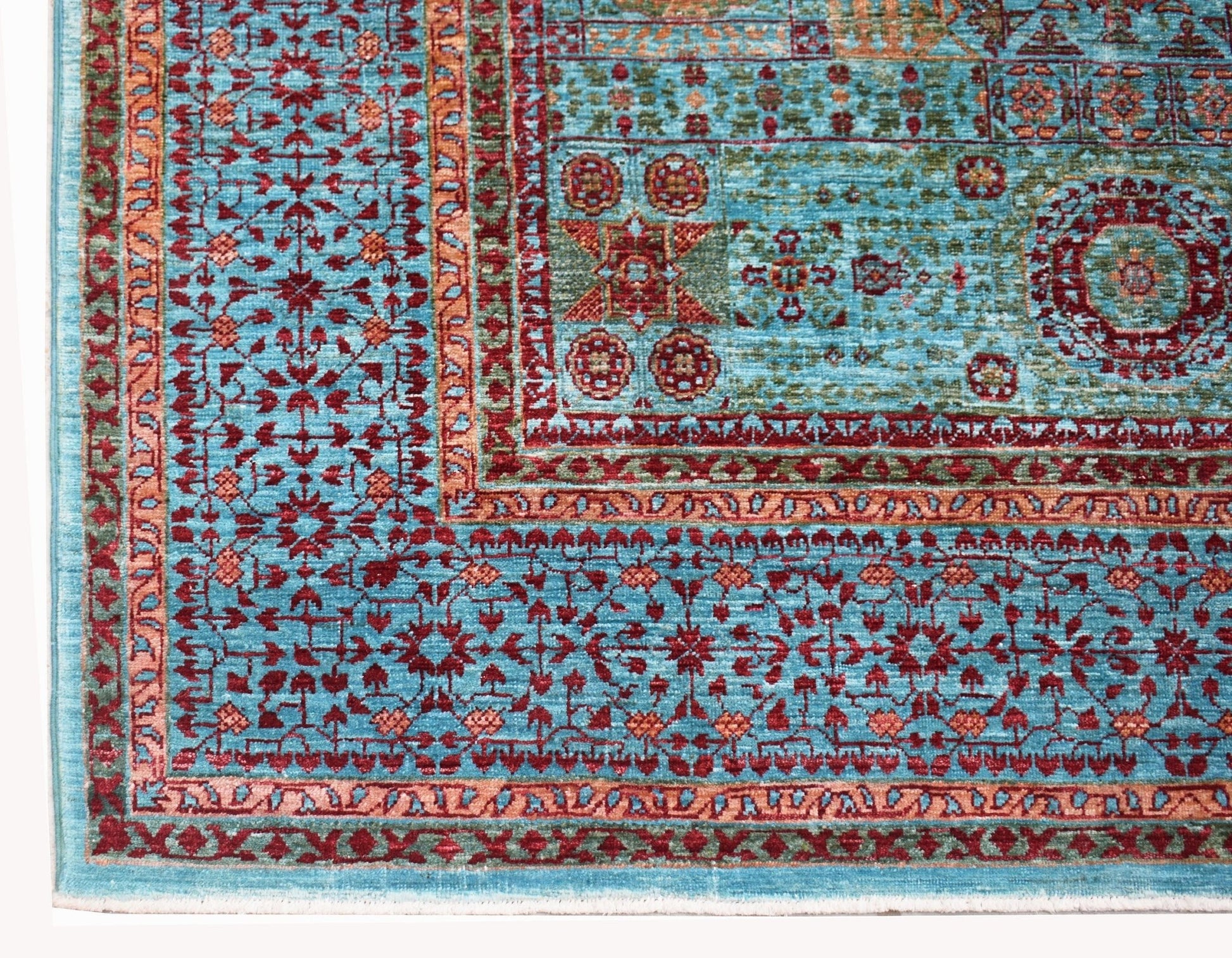 A handwoven Afghan Chobi rug featuring a detailed Mamluk pattern in shades of blue and red.