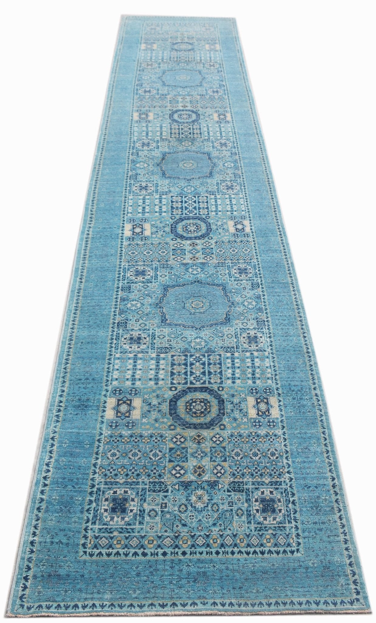 A long, handmade Afghan Chobi runner rug featuring intricate blue Mamluk geometric patterns.