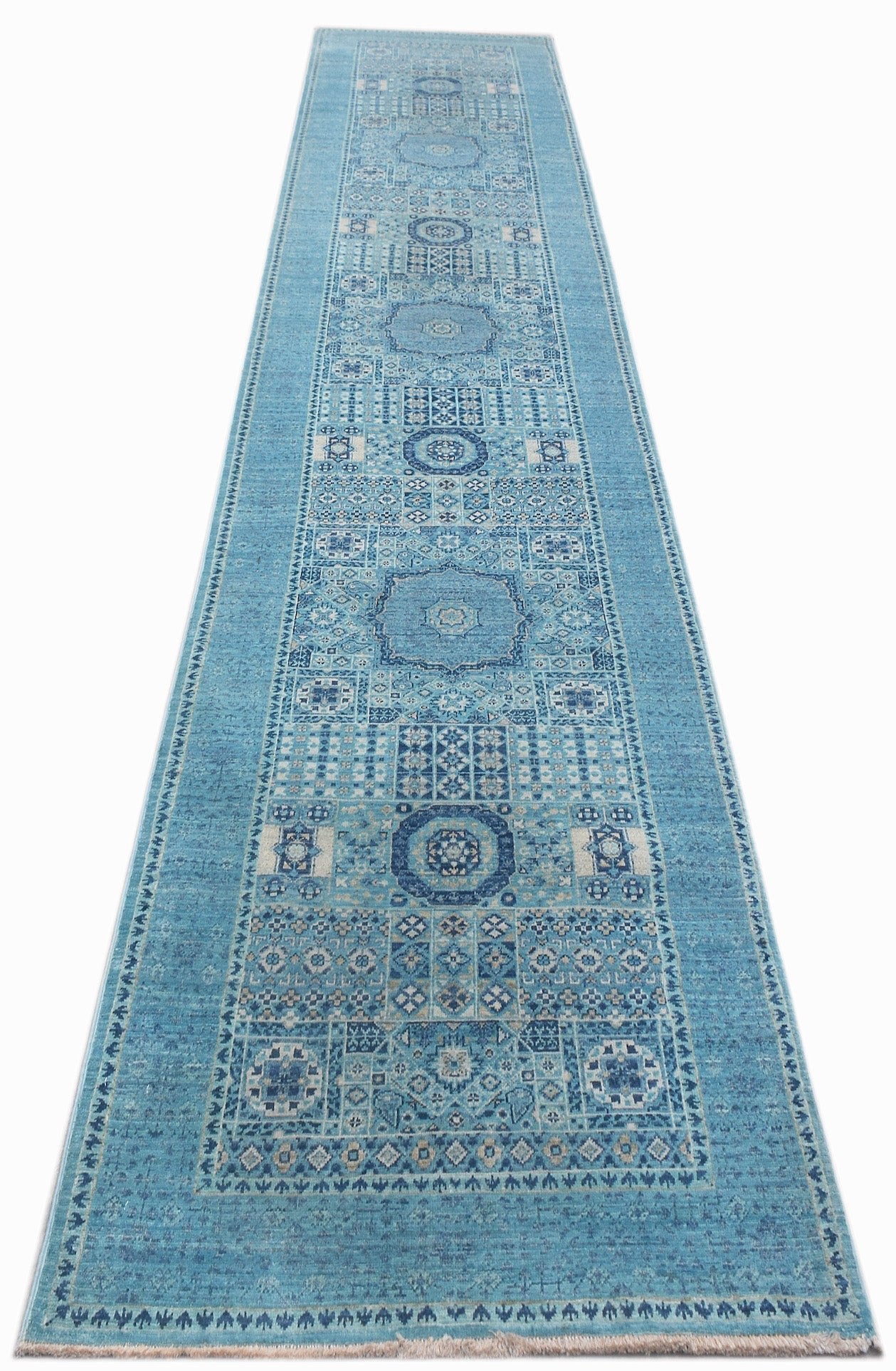 A handmade Afghan Chobi runner rug featuring a blue Mamluk design with intricate medallions.