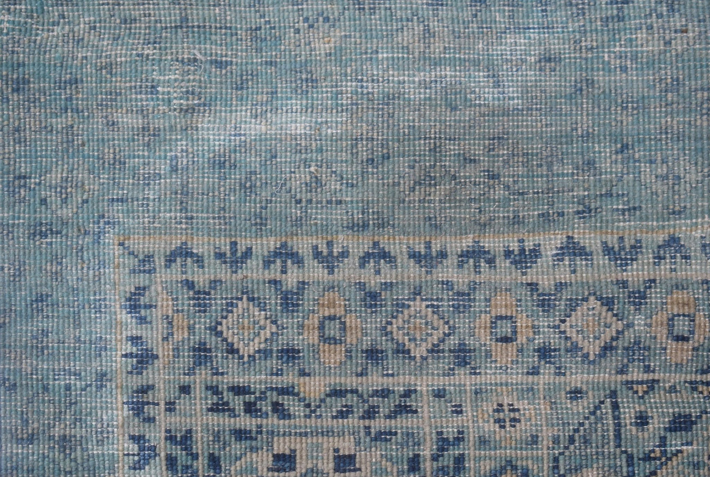 A close-up of a handmade Afghan Chobi runner featuring a blue and beige geometric Mamluk pattern.