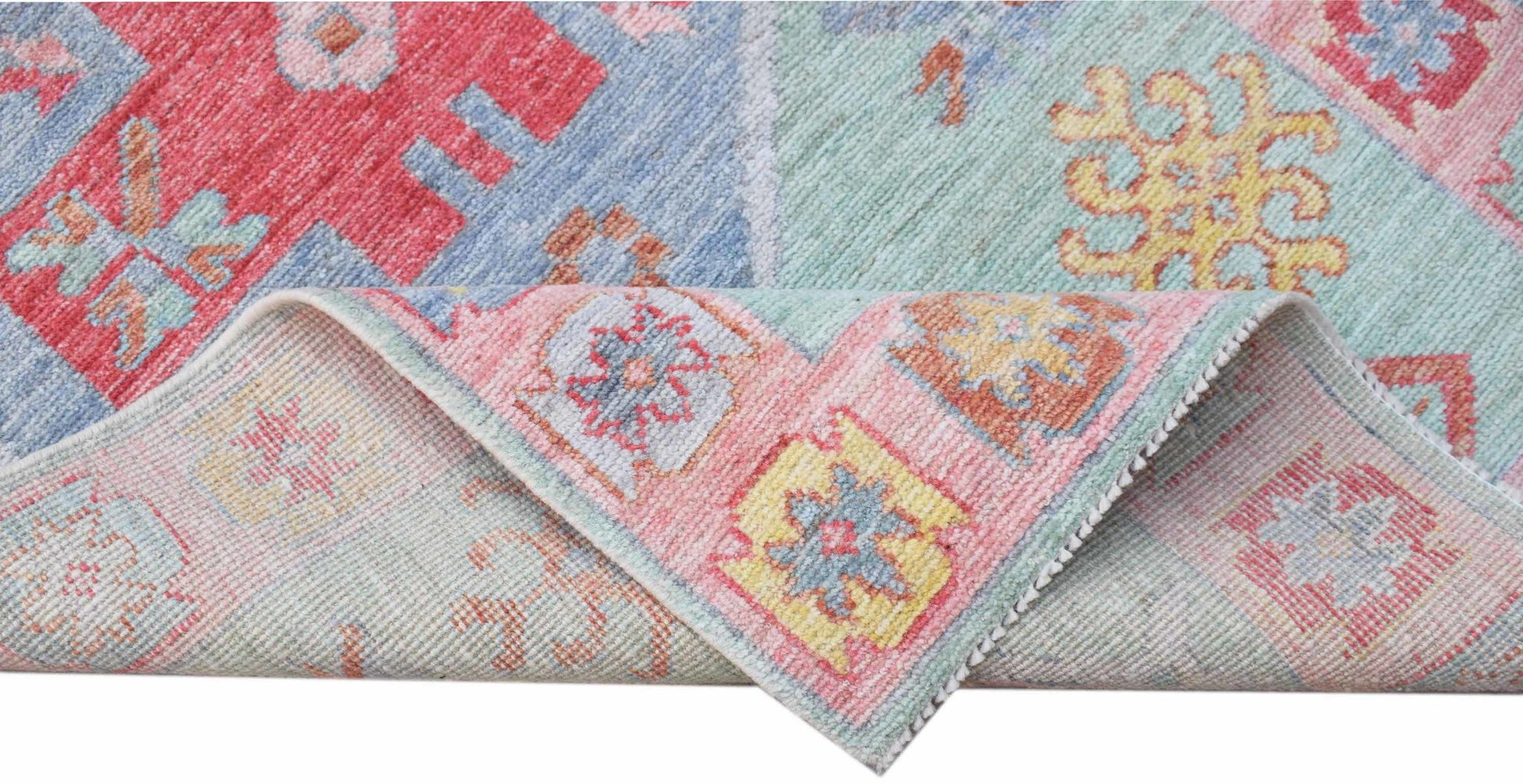 A handwoven transitional Oushak runner featuring a colorful floral pattern in wool.