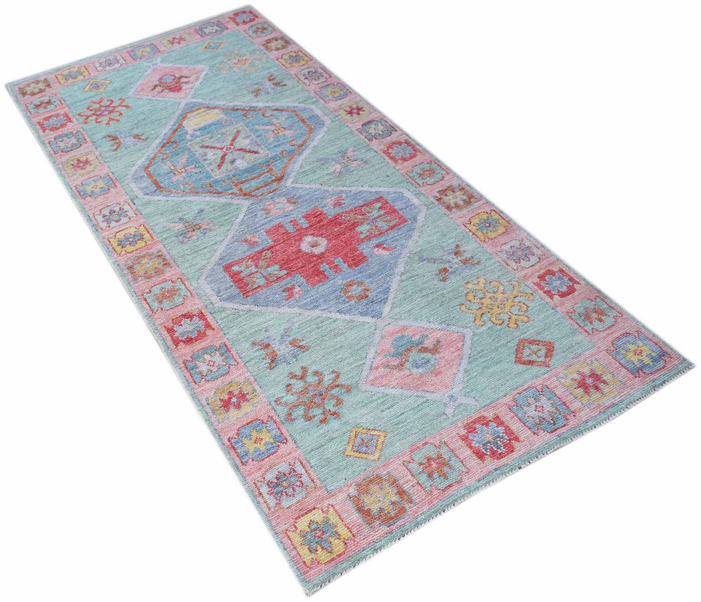 A handwoven transitional Oushak runner featuring a light blue field with geometric floral motifs.