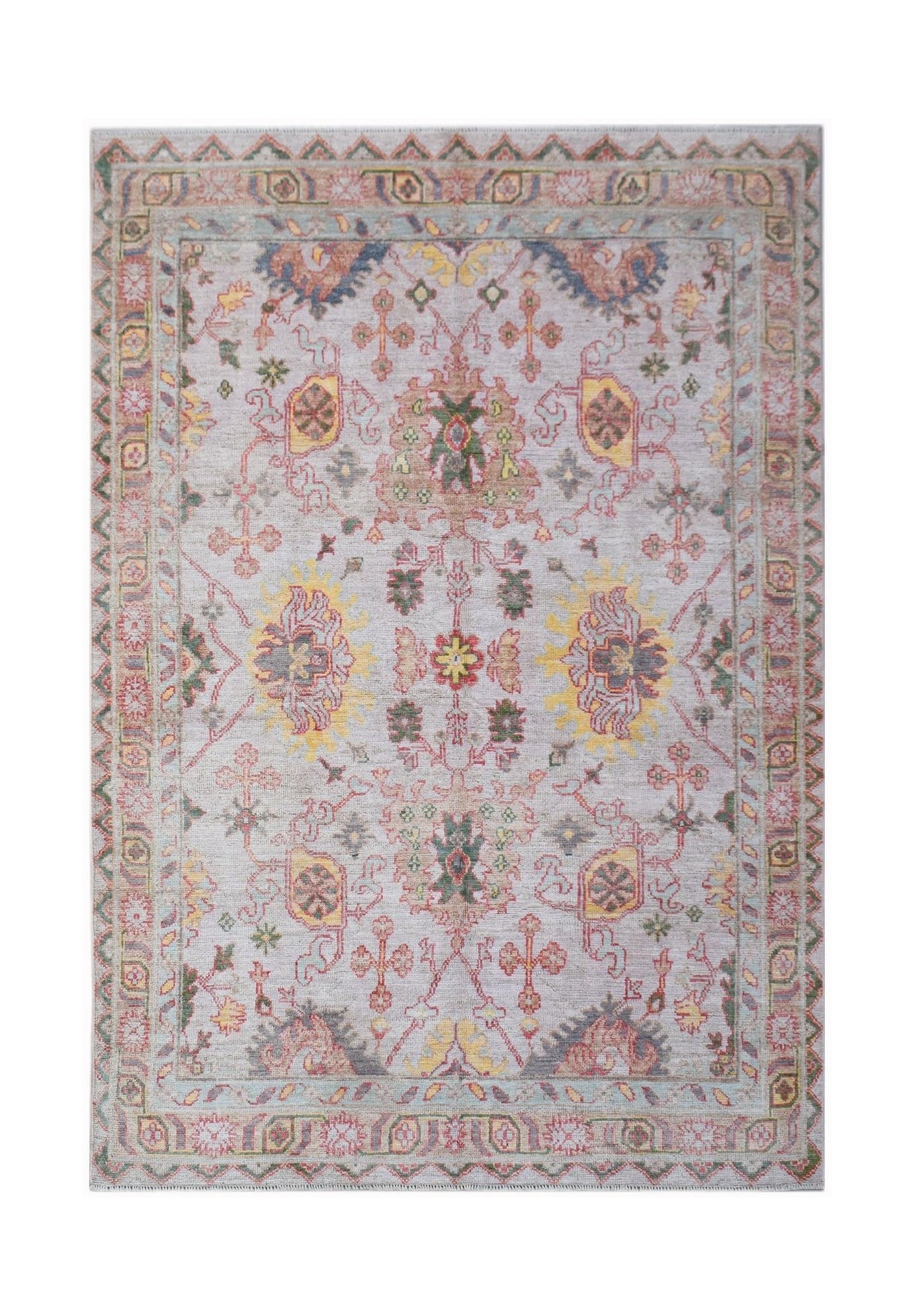 A handwoven transitional Oushak rug featuring a floral pattern in soft, contemporary colors.