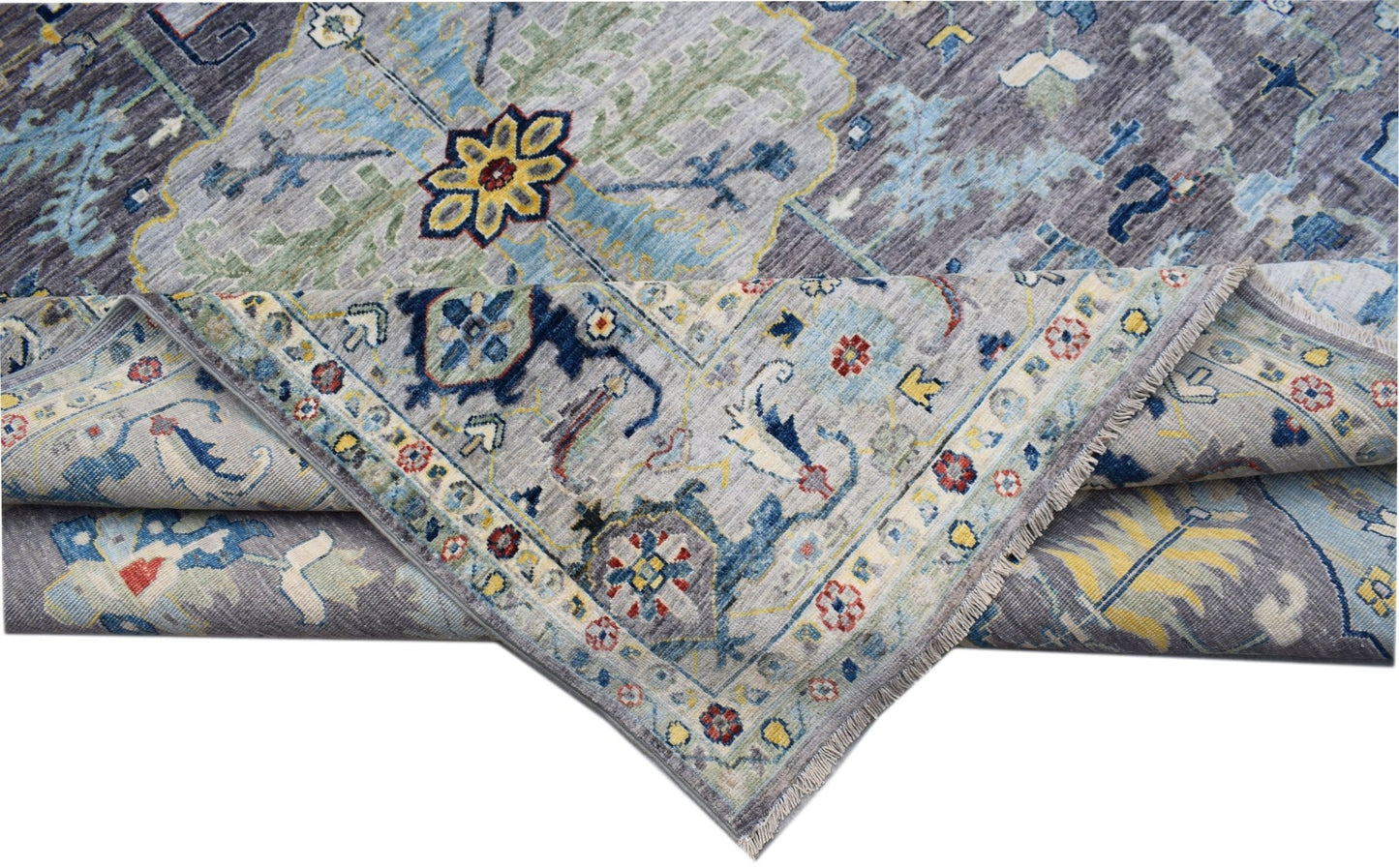 A handwoven transitional Oushak rug featuring a floral pattern in blue, grey, and yellow tones.