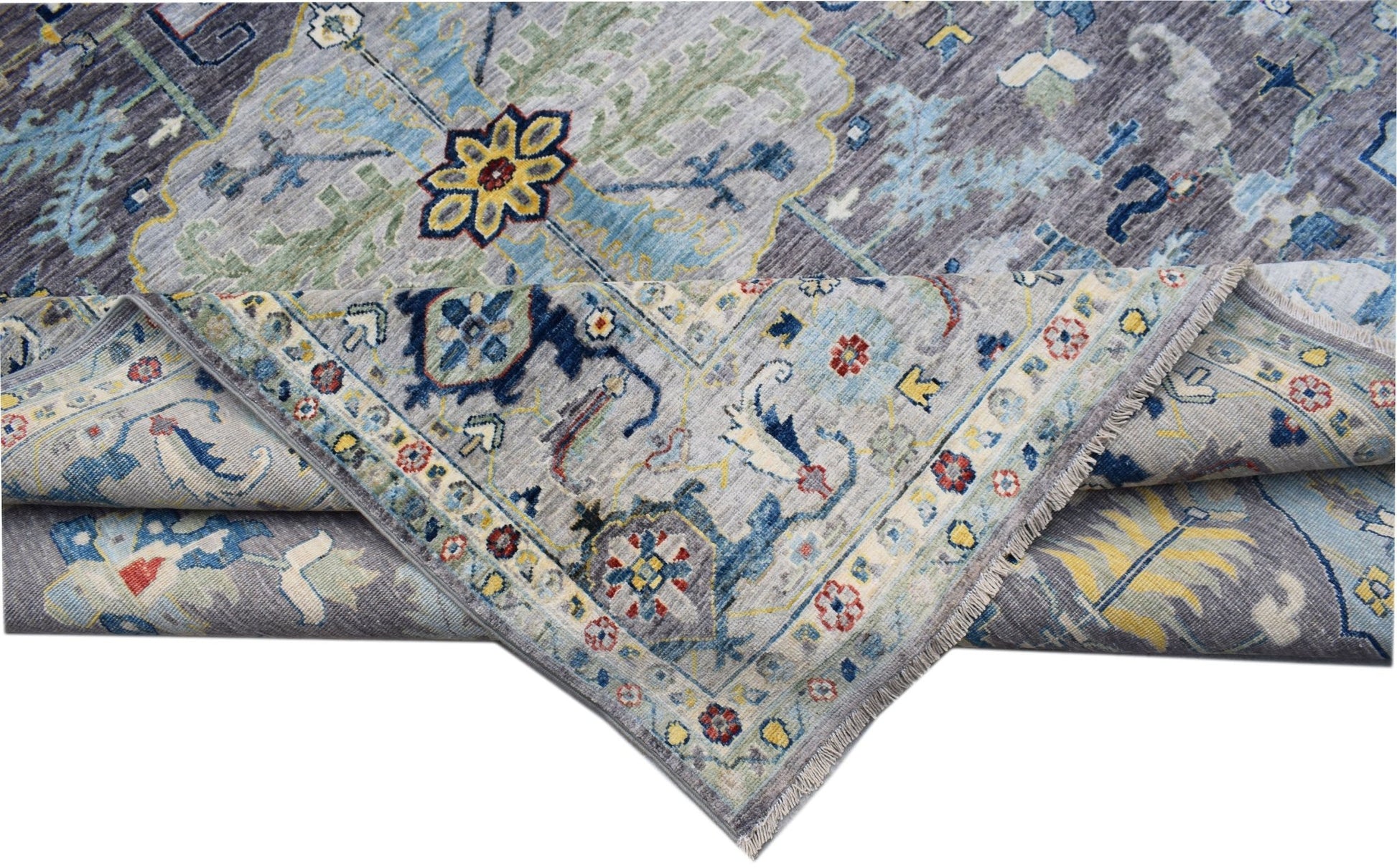 A handwoven transitional Oushak rug featuring a floral pattern in blue, grey, and yellow tones.