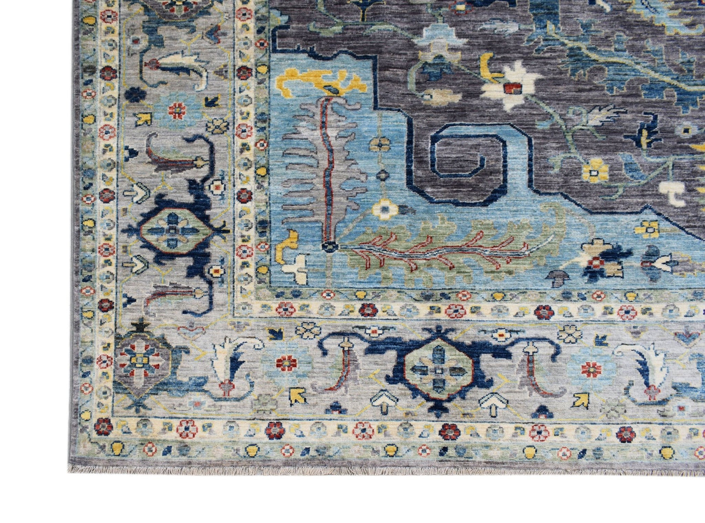 A handwoven transitional Oushak rug featuring a floral pattern in blue, grey, and multi-color tones.