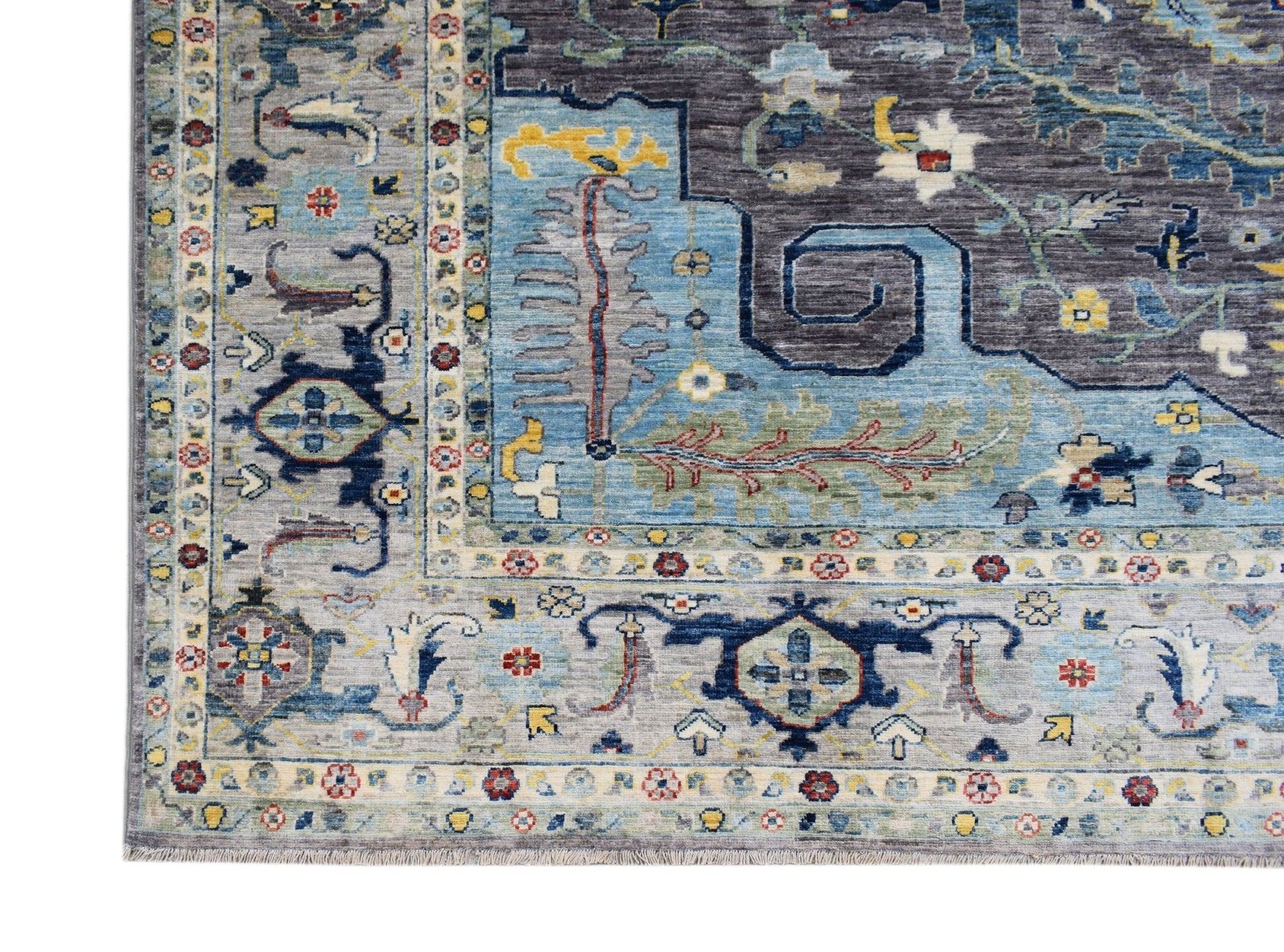 A handwoven transitional Oushak rug featuring a floral pattern in blue, grey, and multi-color tones.