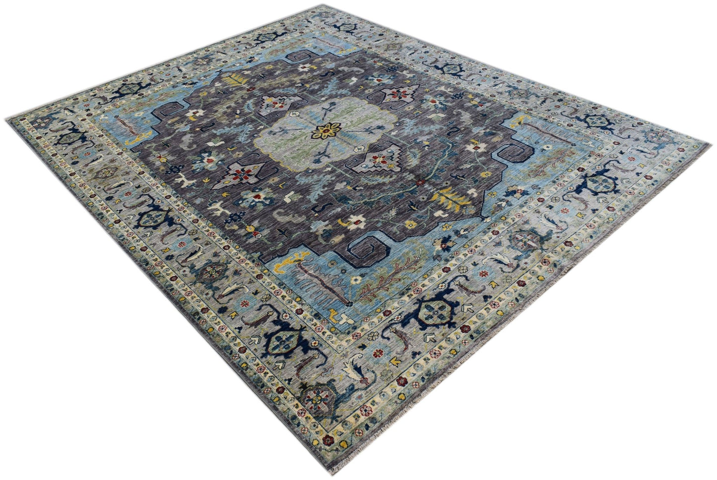 A handwoven transitional Oushak rug featuring a floral pattern in shades of blue and grey.