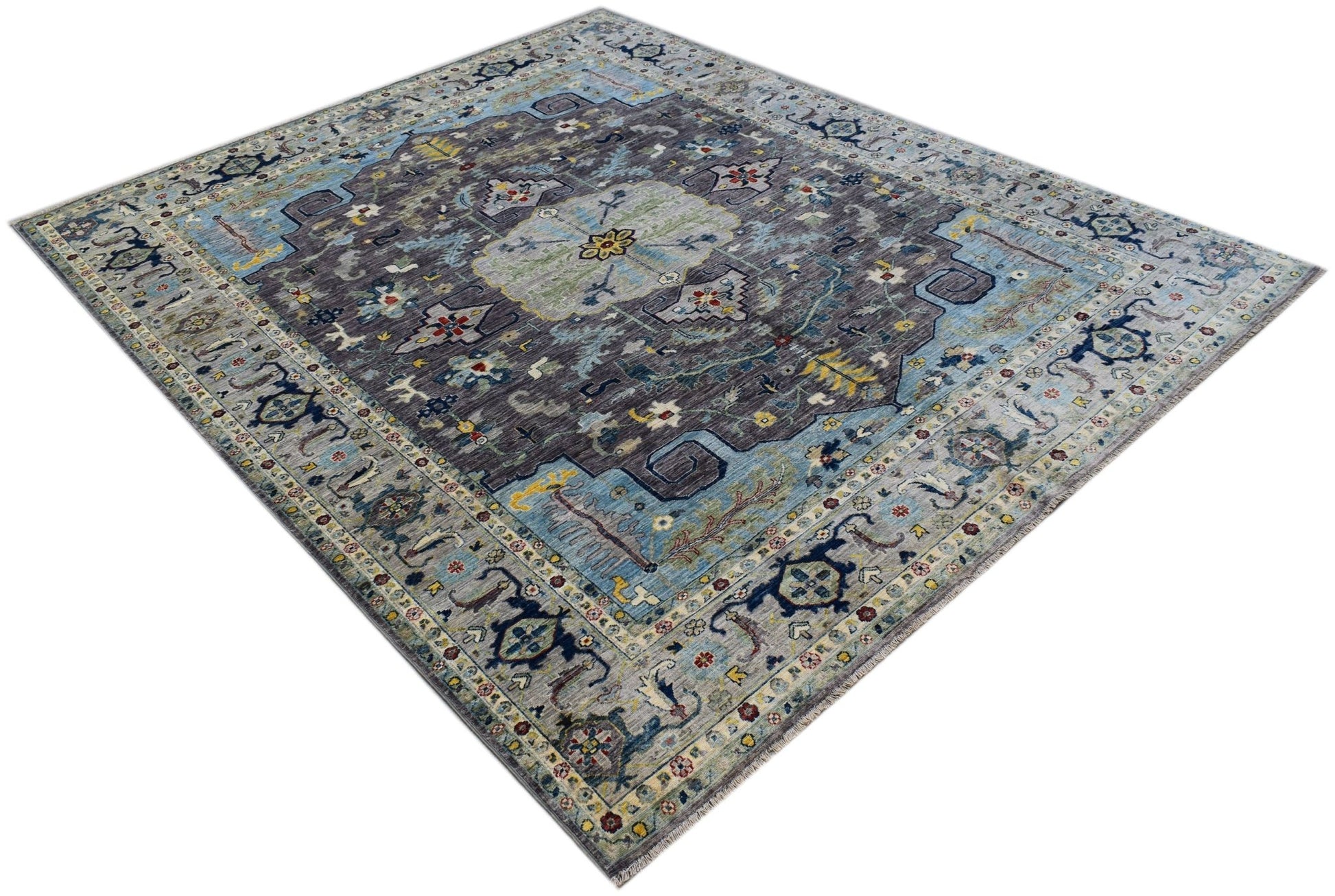 A handwoven transitional Oushak rug featuring a floral pattern in shades of blue and grey.
