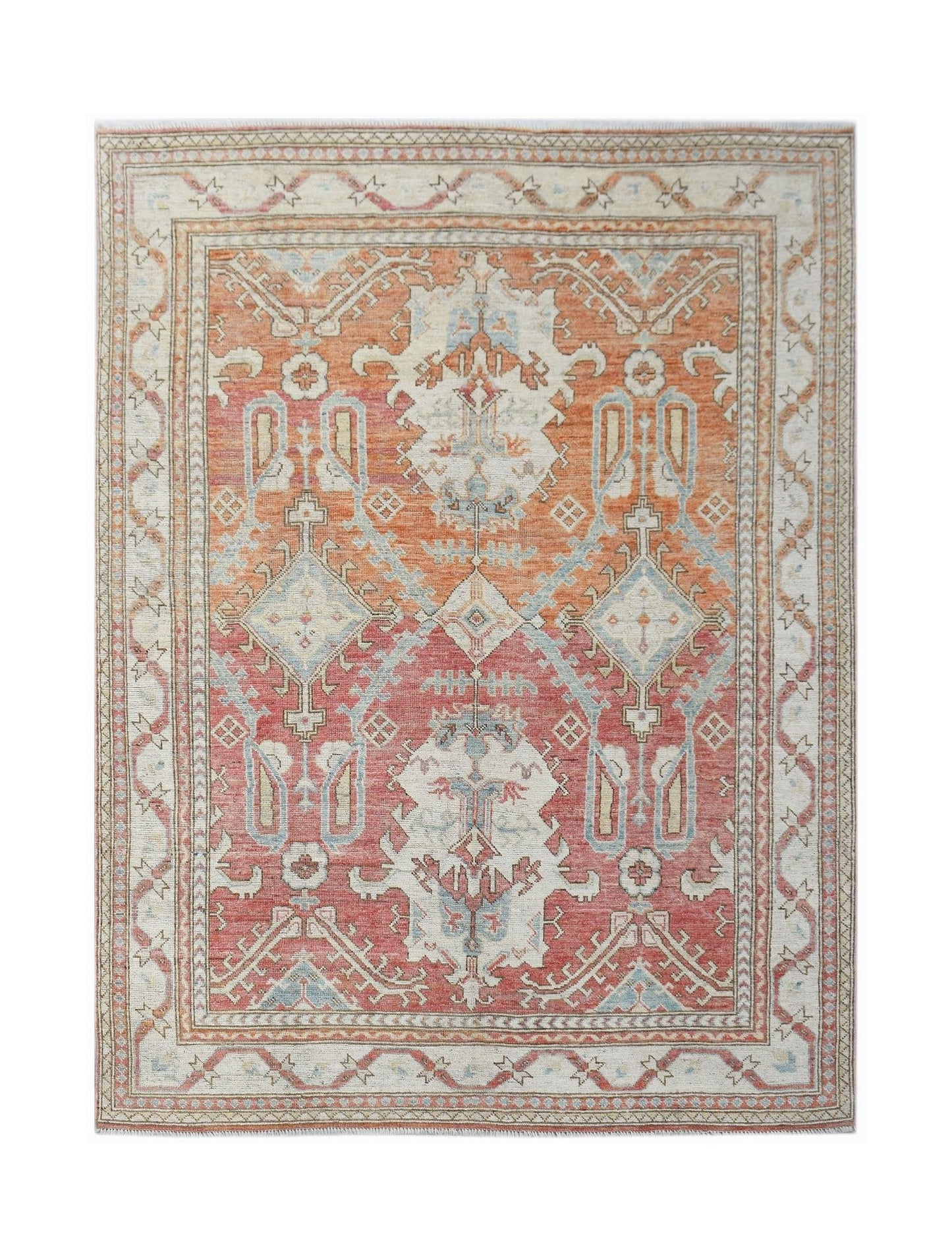 A handwoven transitional Oushak rug featuring a geometric floral pattern in orange and red tones.