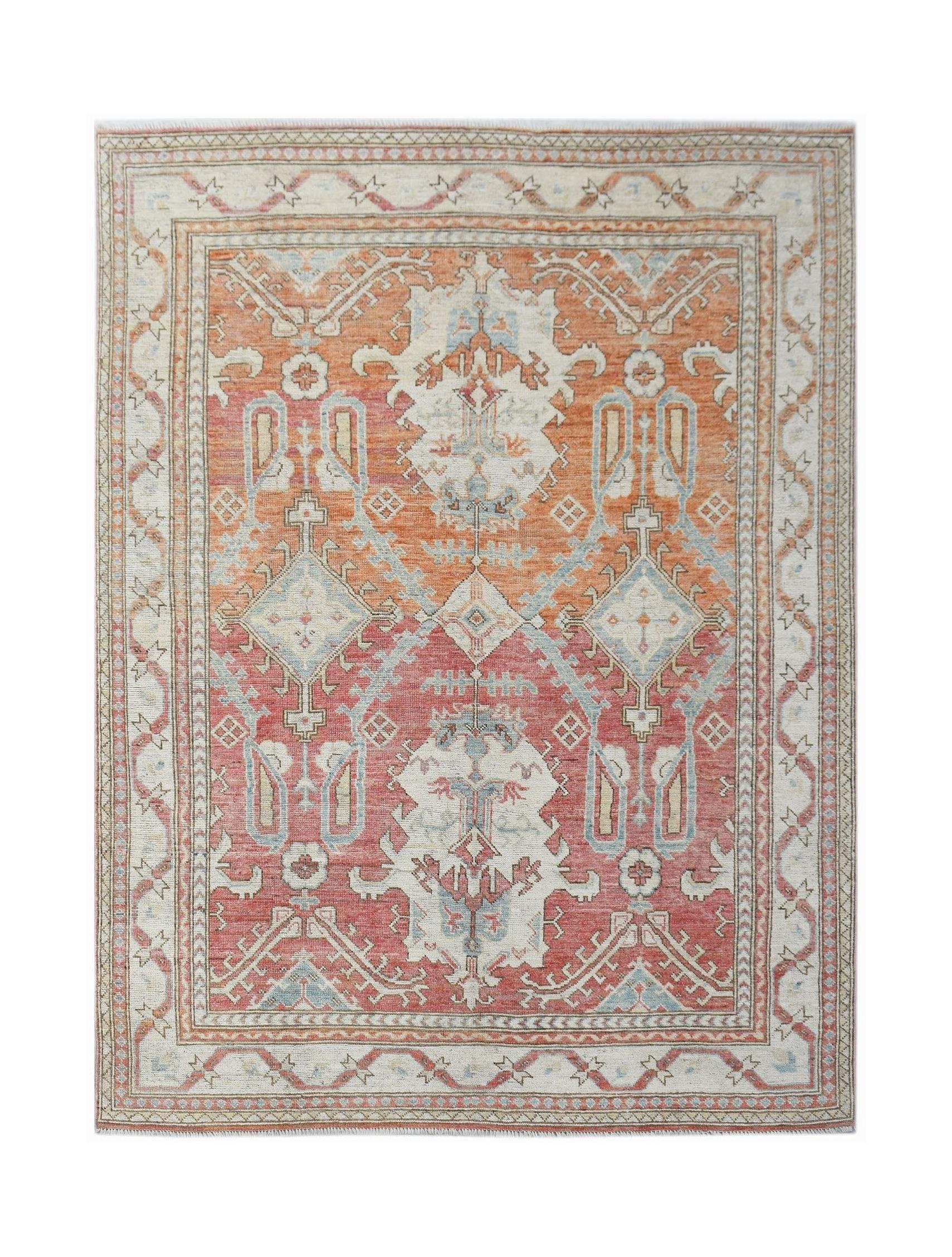 A handwoven transitional Oushak rug featuring a geometric floral pattern in orange and red tones.