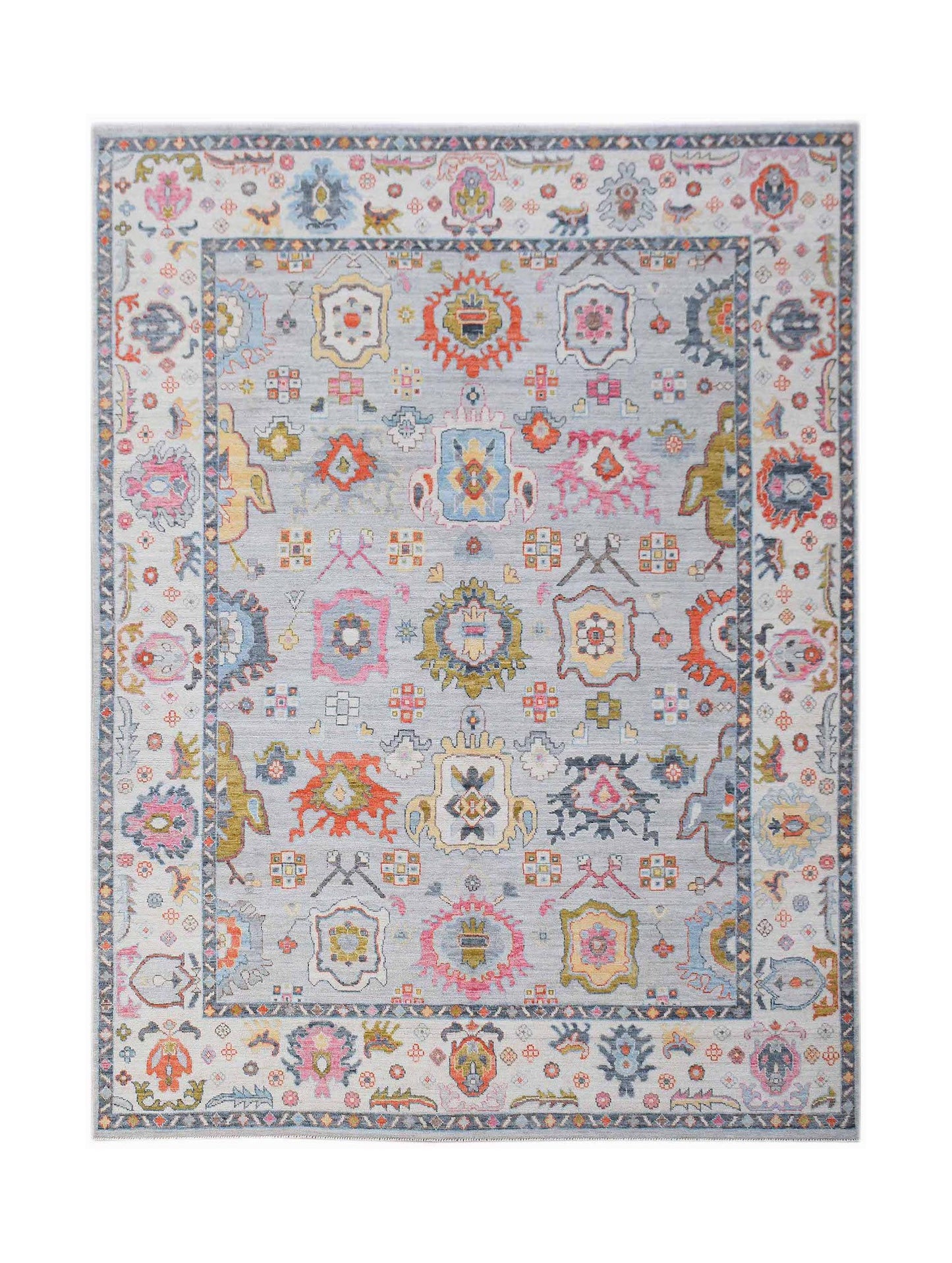 A handwoven transitional Oushak rug featuring a light blue field with colorful floral motifs.