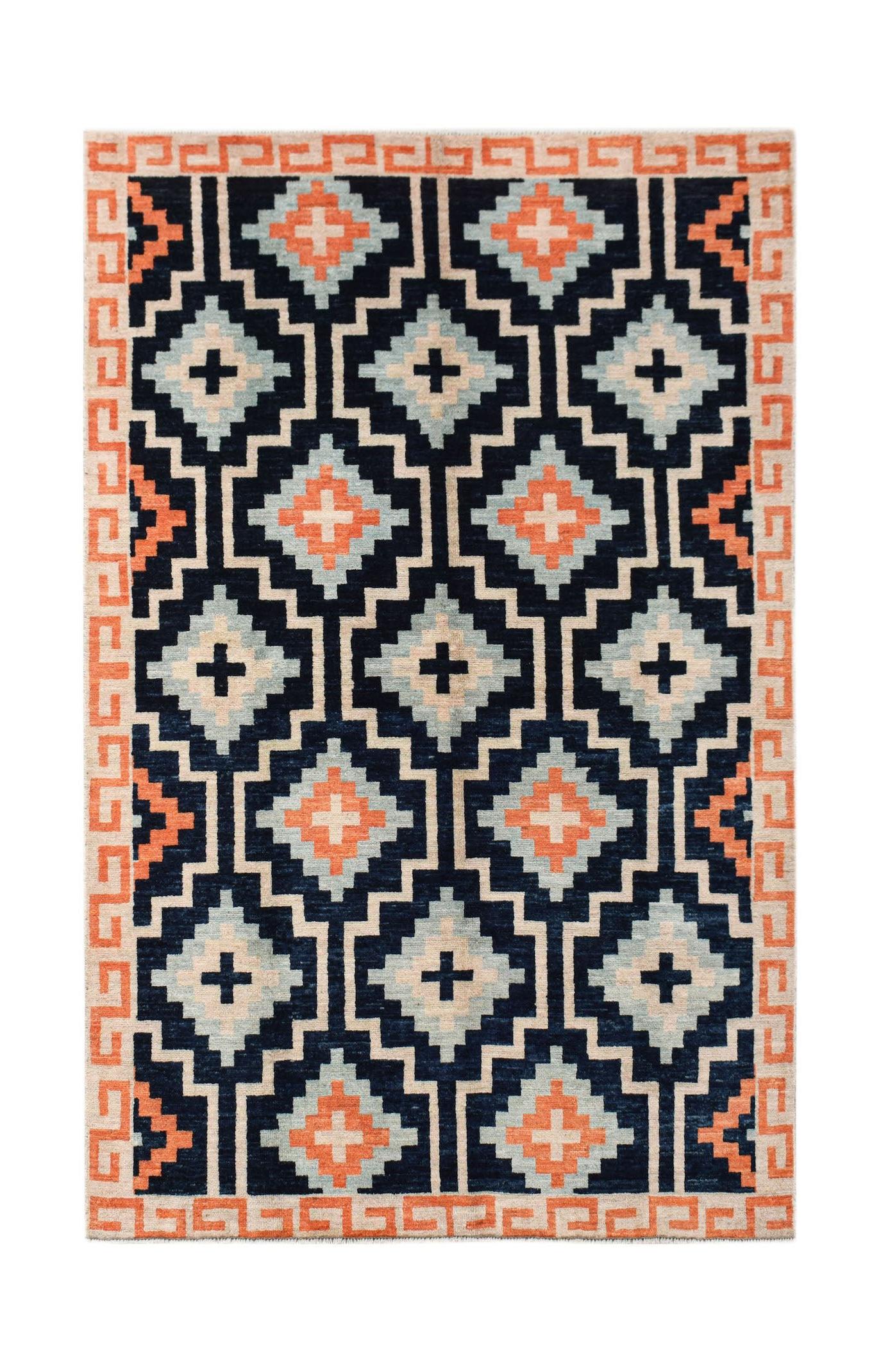 A hand-knotted wool rug featuring a dark blue background with geometric orange and light blue motifs.
