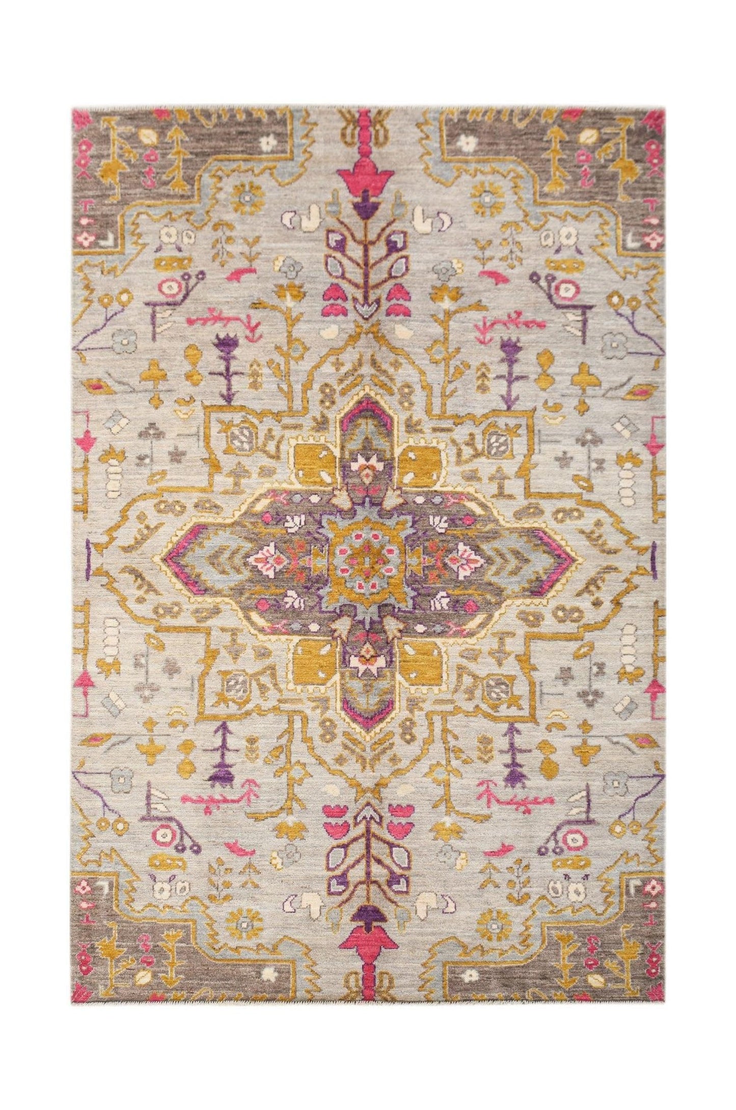 A hand-knotted wool rug featuring a transitional geometric medallion in grey, gold, and pink.