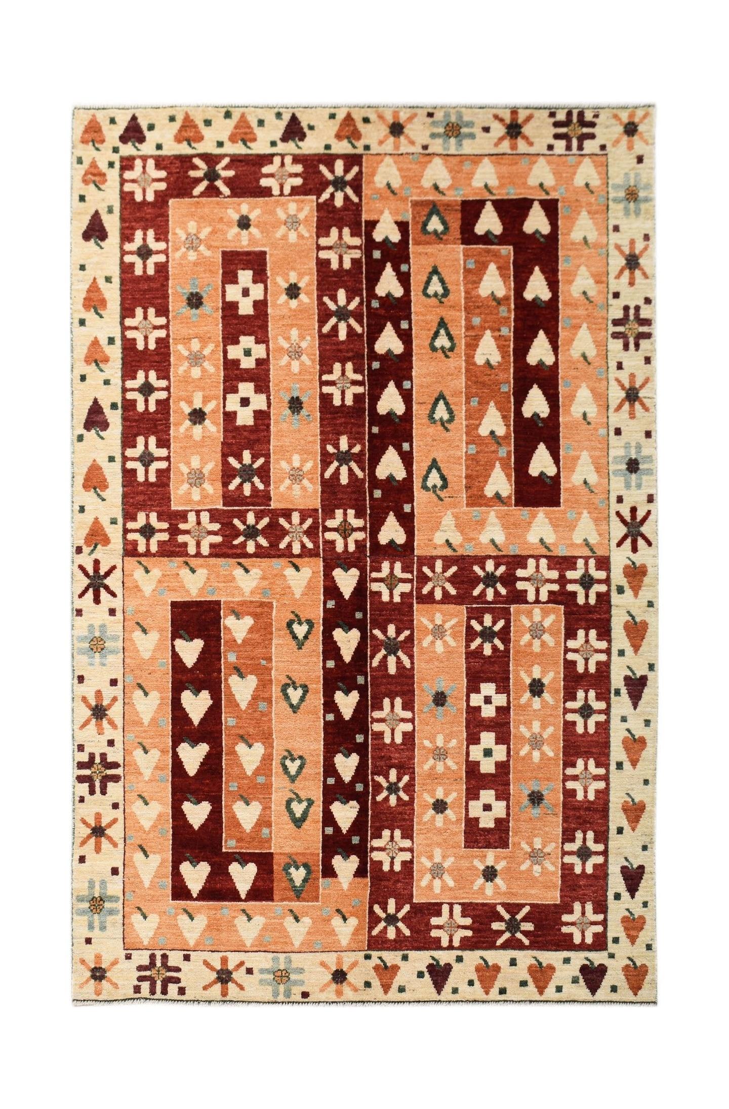 A hand-knotted wool rug featuring a geometric pattern of orange and dark red rectangular blocks.