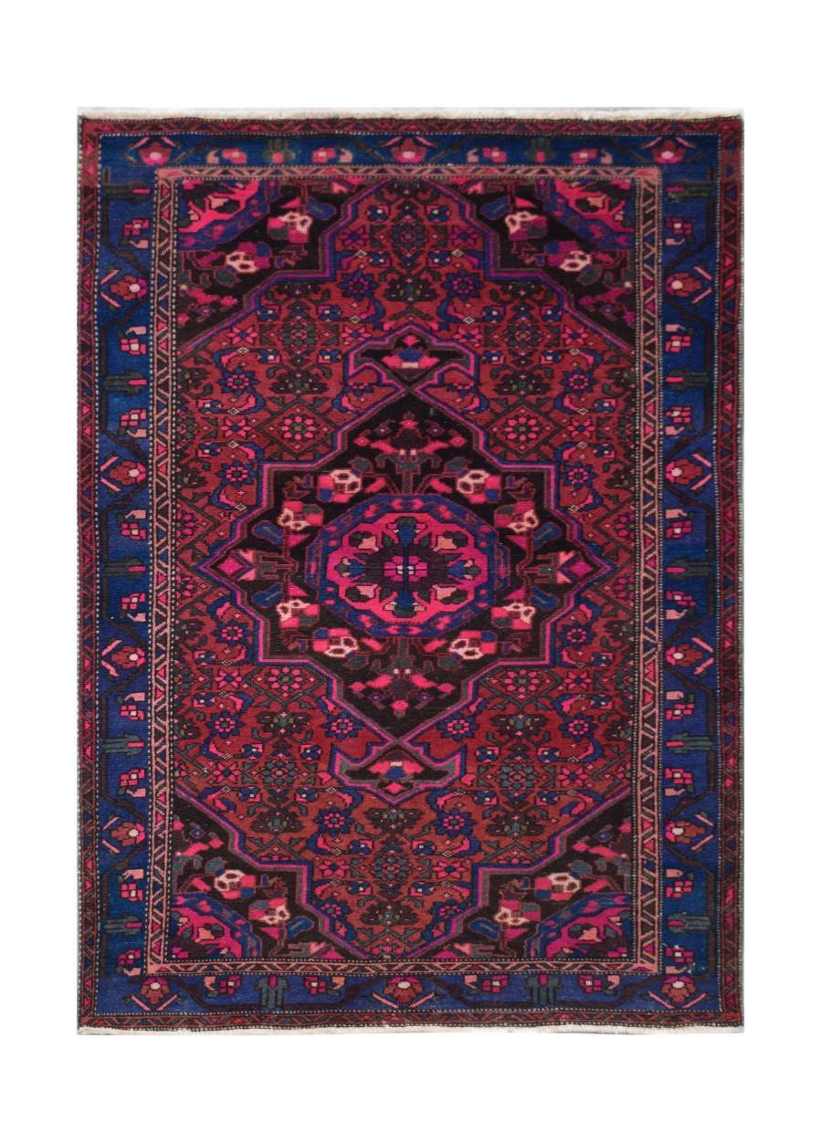 A rectangular handmade Persian rug featuring a central medallion in shades of red, blue, and black.
