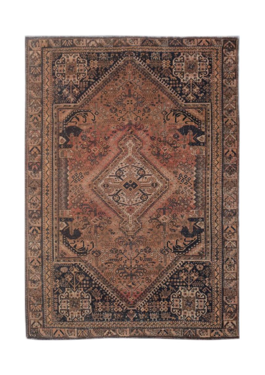 A handmade vintage Persian wool rug featuring a central diamond medallion in rust and navy tones.