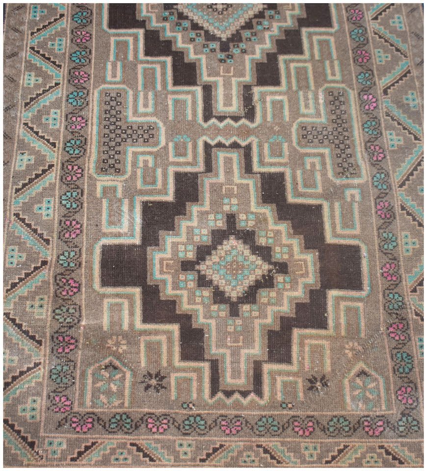A handmade vintage Afghan Baluch runner featuring geometric diamond patterns in brown and teal.