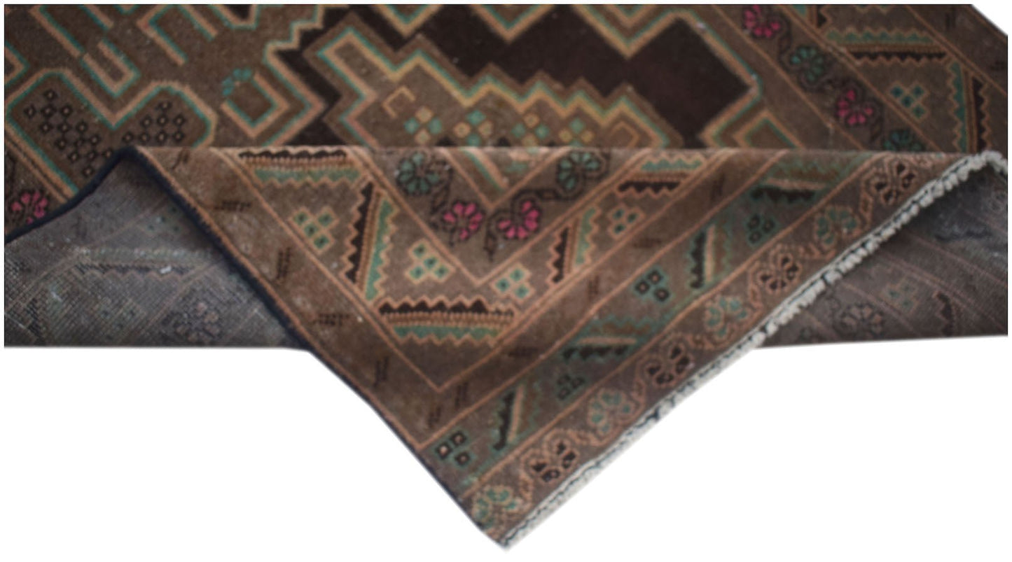 A vintage handmade Afghan Baluch runner with a brown geometric pattern and floral accents.