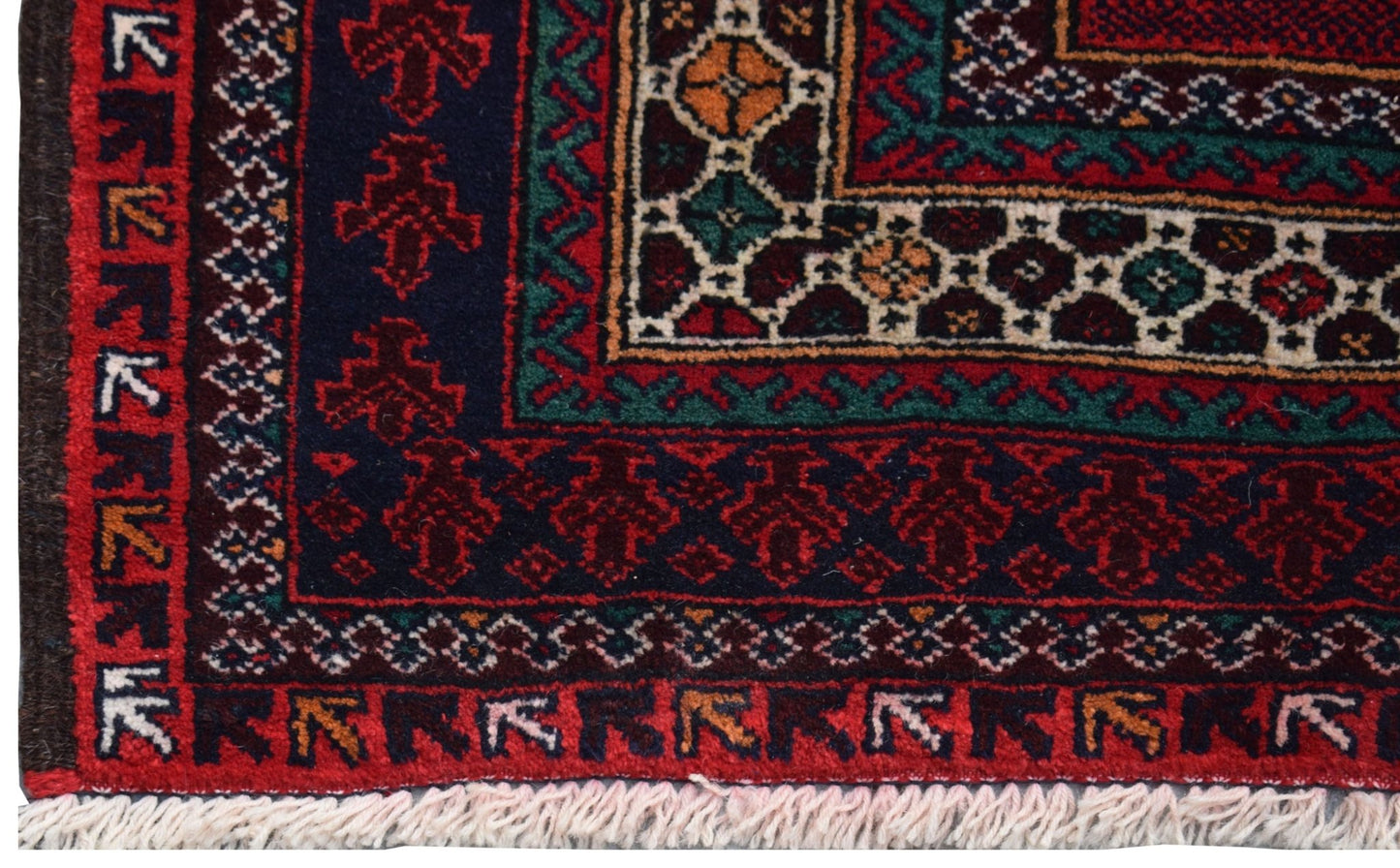 A vintage handmade Afghan Baluch rug featuring traditional geometric patterns in red, blue, and ivory.