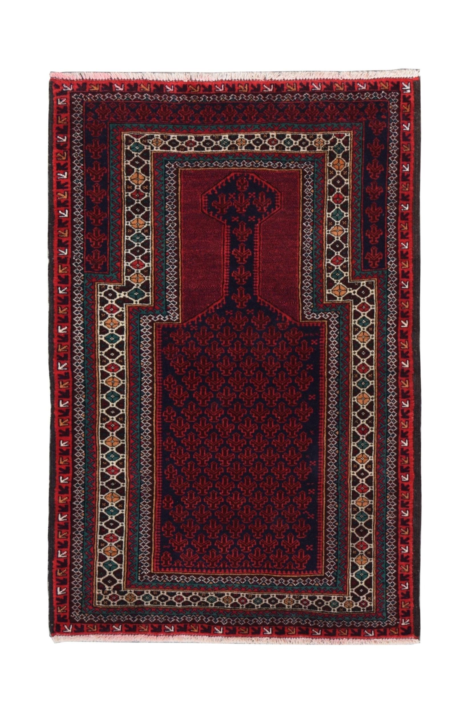 A handmade vintage Afghan Baluch rug featuring a traditional prayer design in deep red and blue.
