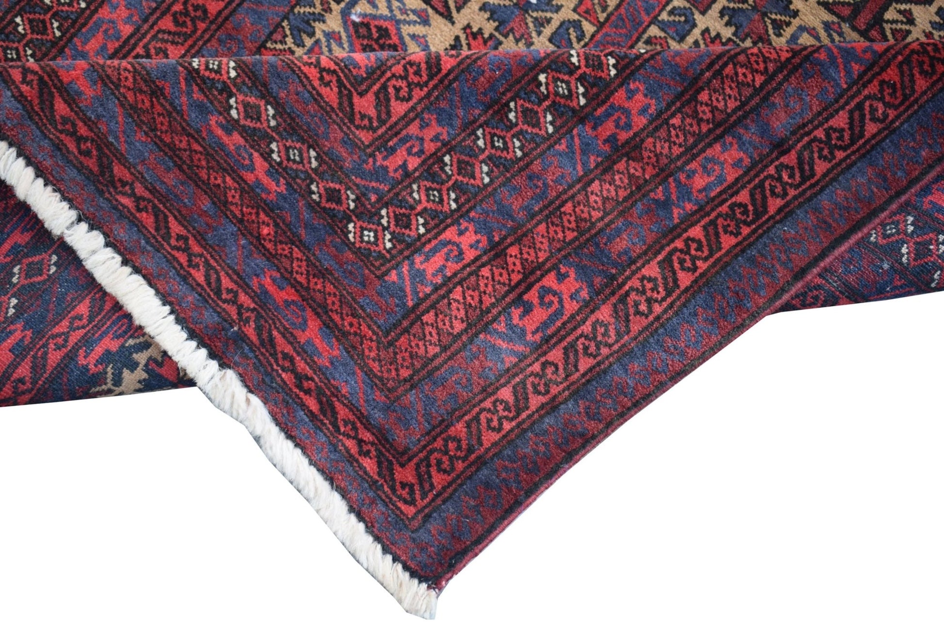 A vintage handmade Afghan Baluch rug featuring geometric patterns in deep red, blue, and brown.