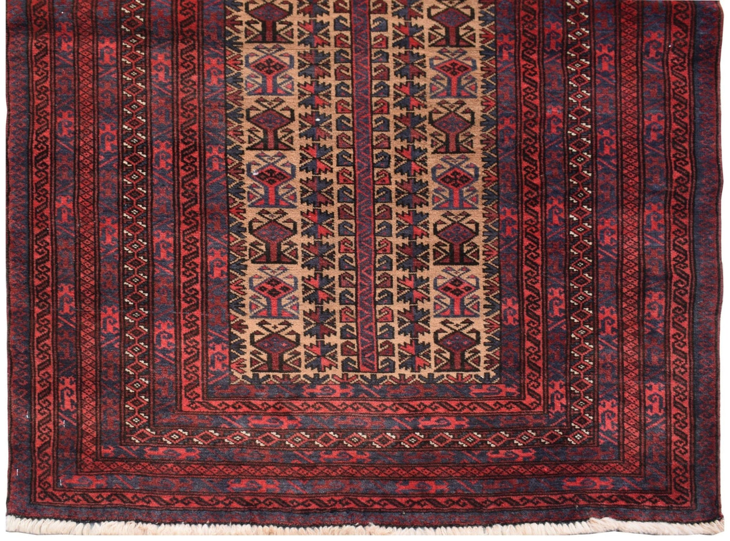 A vintage handmade Afghan Baluch rug featuring geometric tribal patterns in red, brown, and blue.