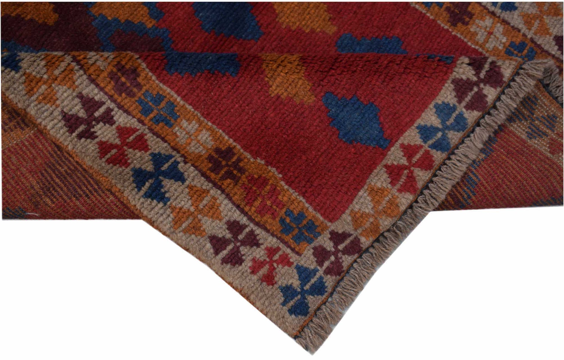 Handmade Afghan Pashm rug featuring a geometric pattern in red, blue, and gold wool.