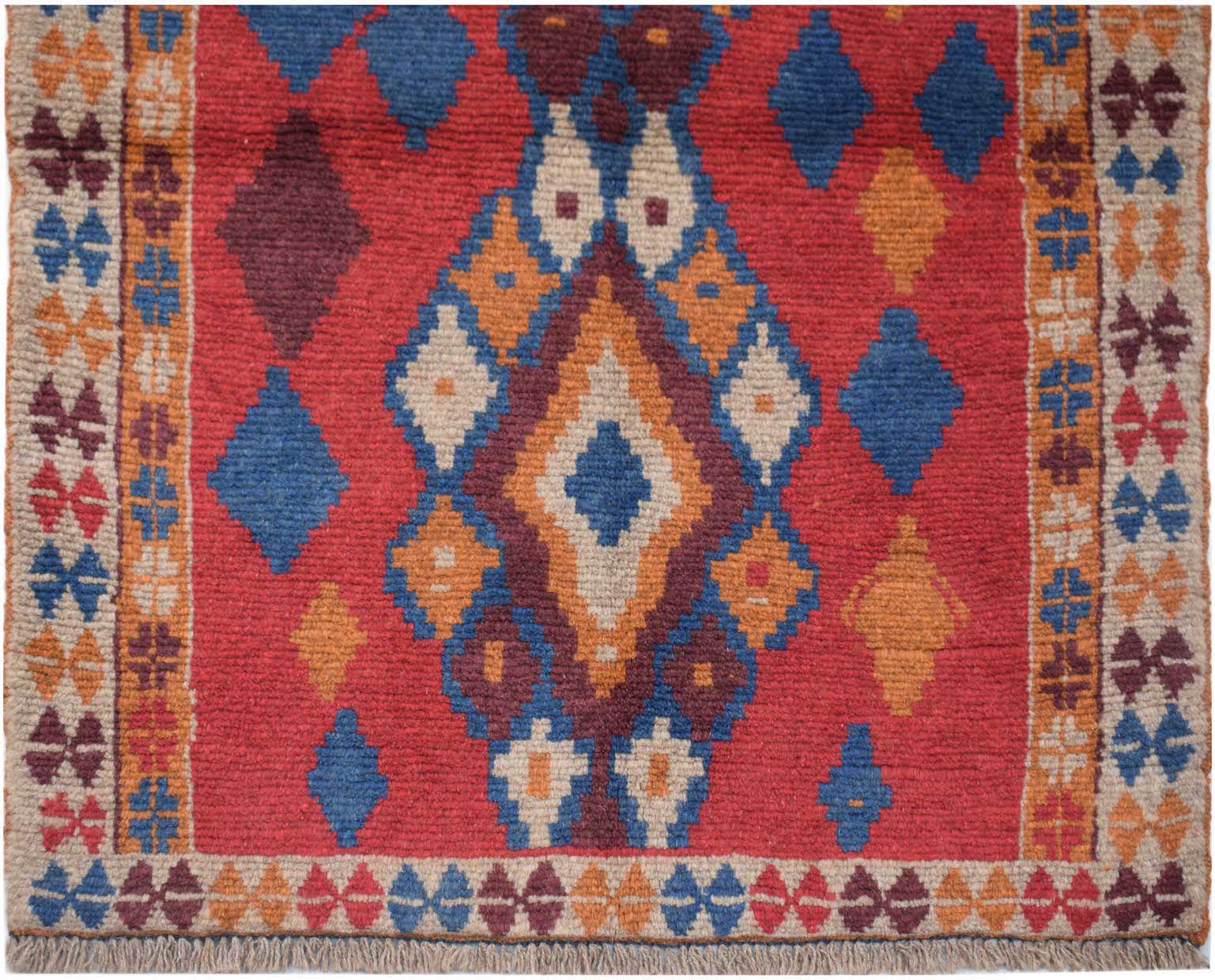 Handmade Afghan Pashm rug featuring a geometric diamond pattern in red, blue, and ivory wool.
