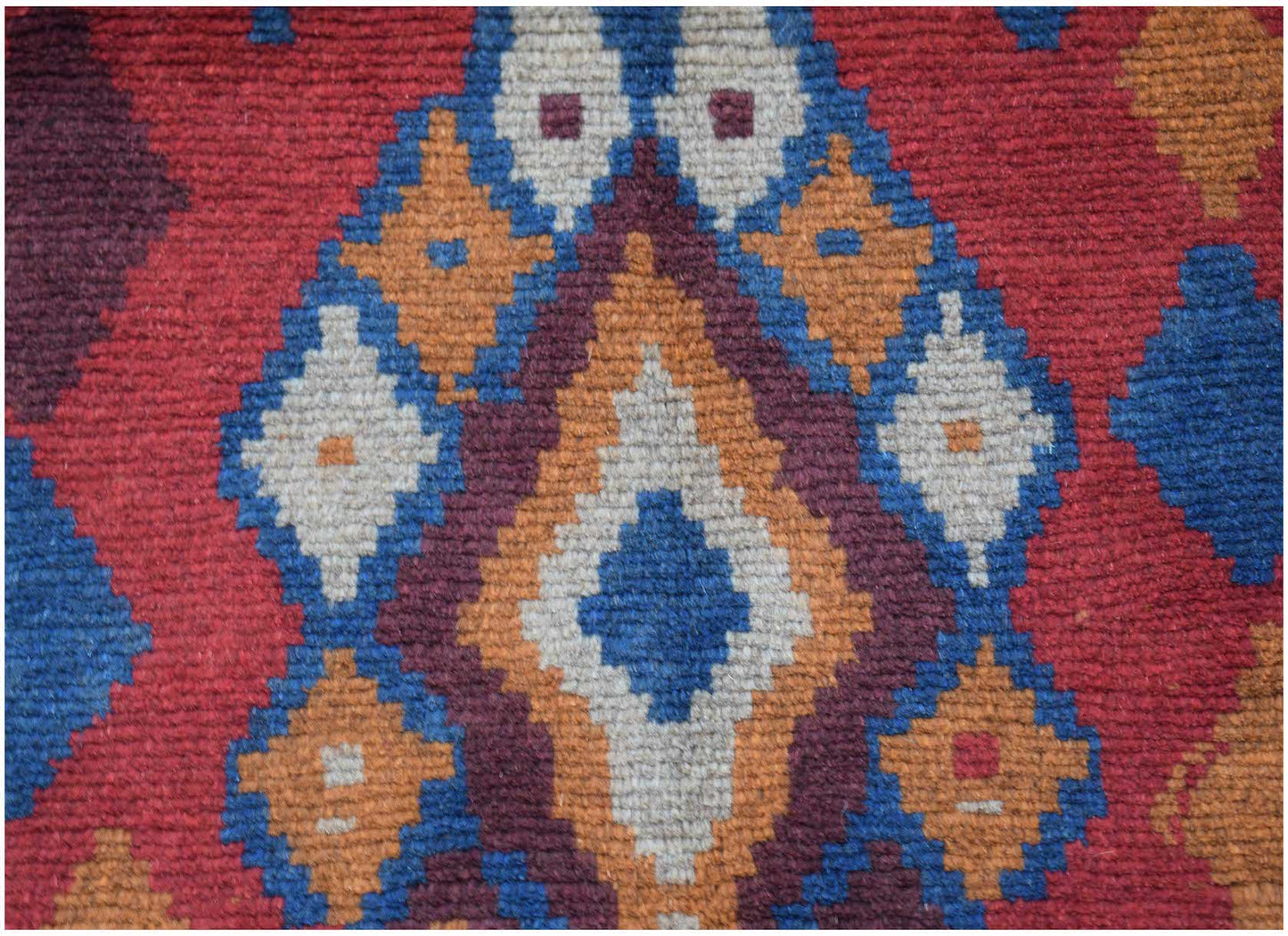 Handmade Afghan Pashm rug featuring a geometric diamond pattern in red, blue, brown, and ivory.