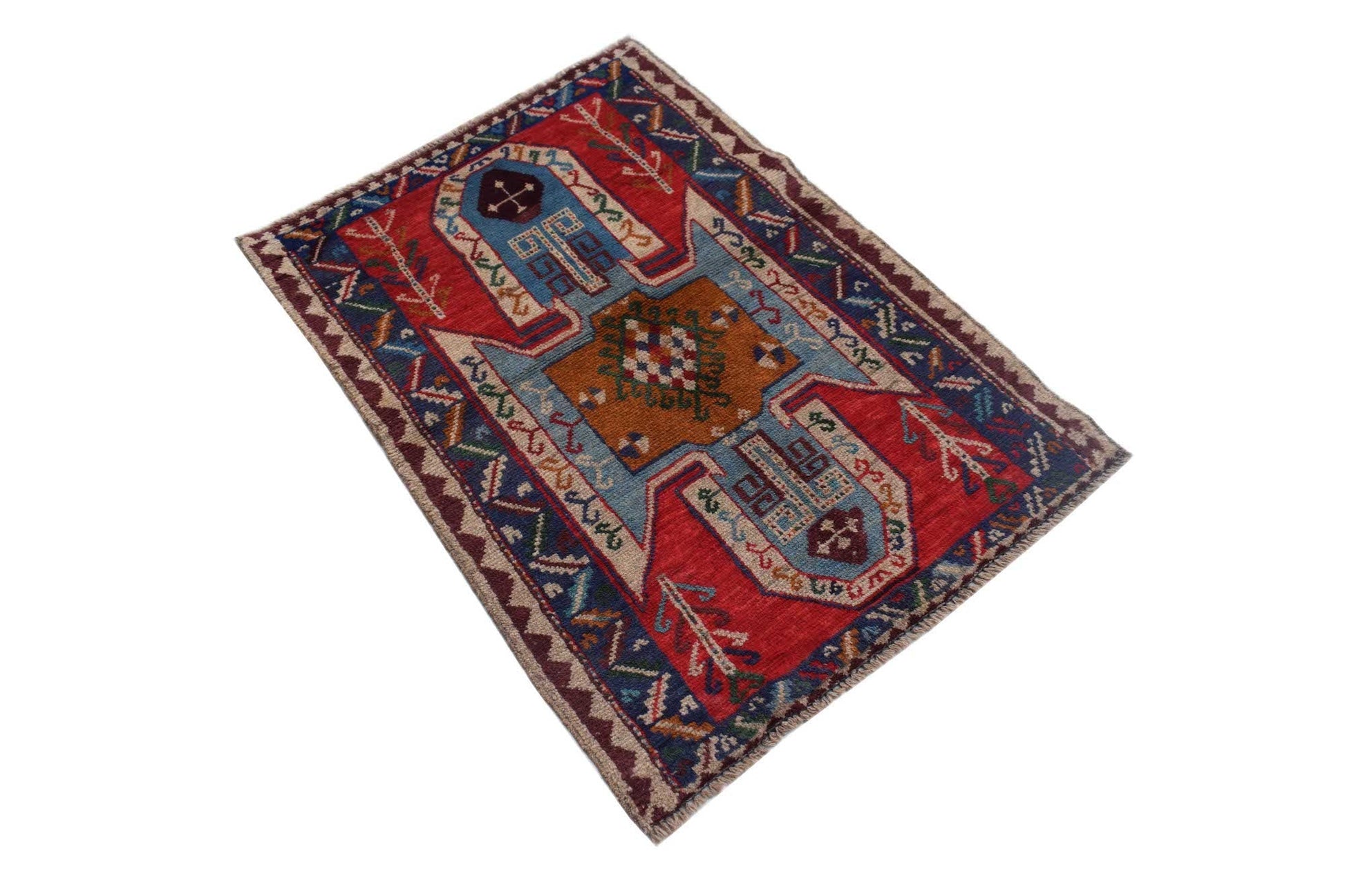 Handmade Afghan Pashm rug featuring a geometric tribal pattern in red, blue, and brown wool.