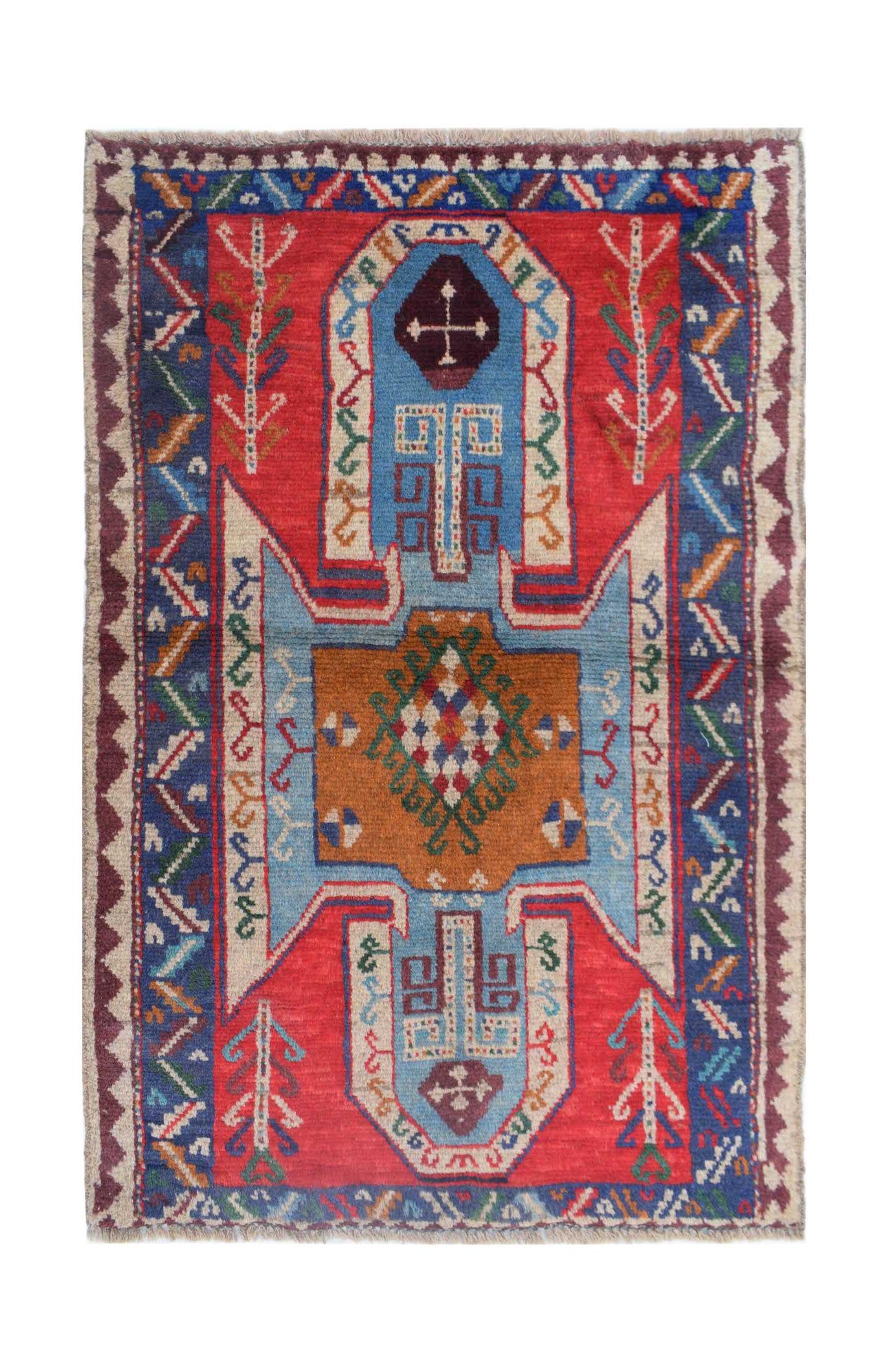 Handmade Afghan Pashm rug featuring a geometric tribal pattern in red, blue, and brown wool.