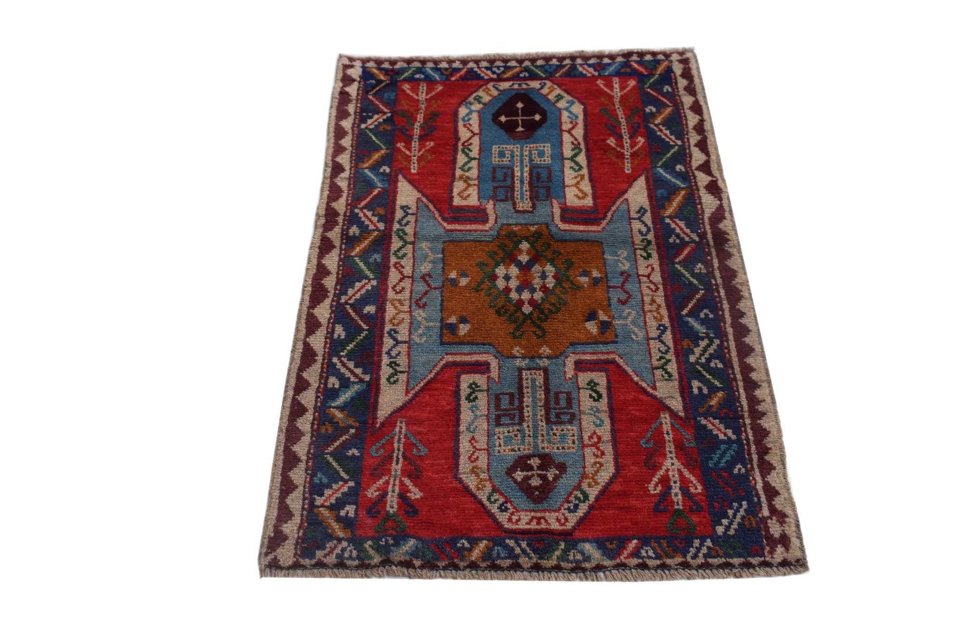 Handmade Afghan Pashm rug featuring a geometric tribal pattern in red, blue, and brown wool.