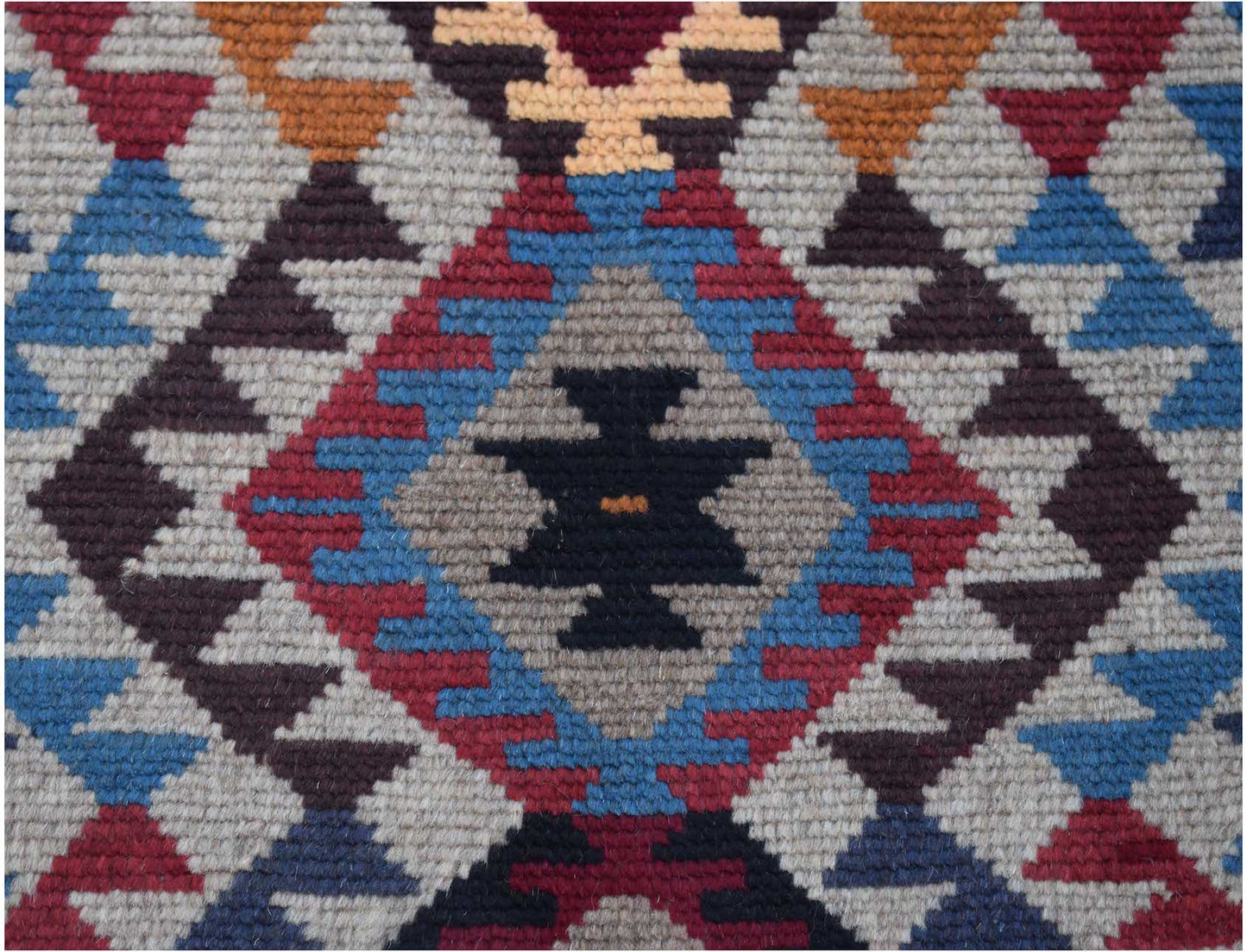 Handmade Afghan Pashm rug featuring a geometric tribal pattern in red, blue, brown, and ivory.