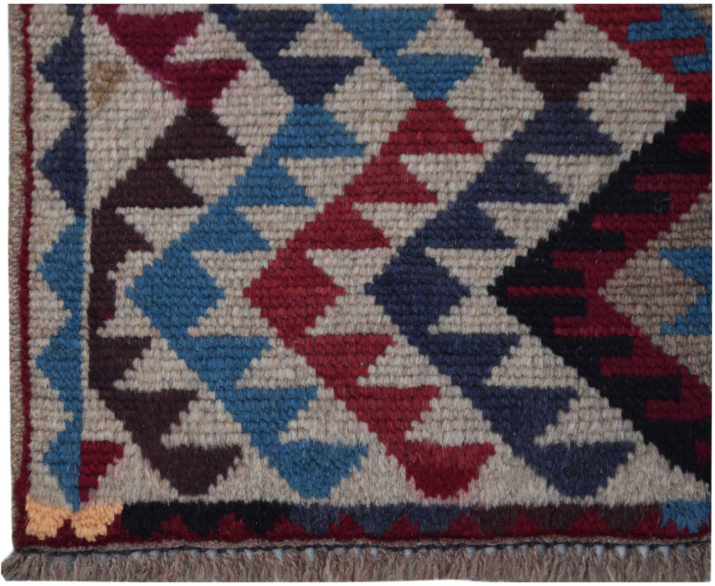 Handmade Afghan Pashm rug featuring a geometric diamond pattern in red, blue, and brown wool.