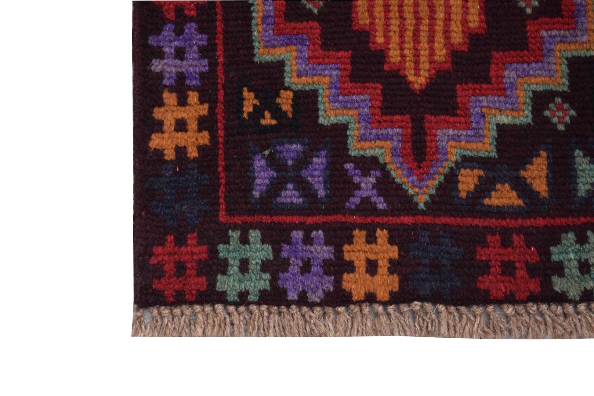 A handmade Afghan Pashm rug featuring a dark background with colorful geometric tribal patterns.