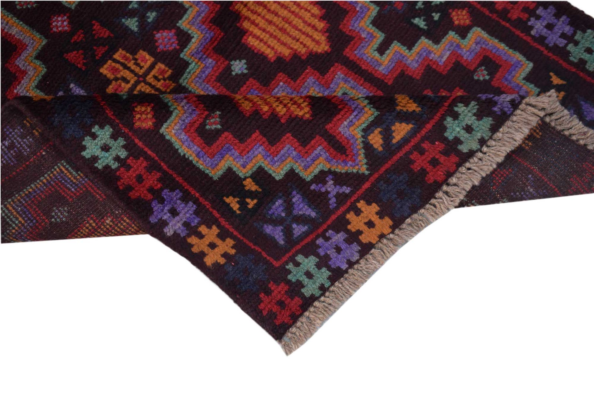 A handmade Afghan Pashm rug featuring geometric patterns in dark red, blue, and orange wool.