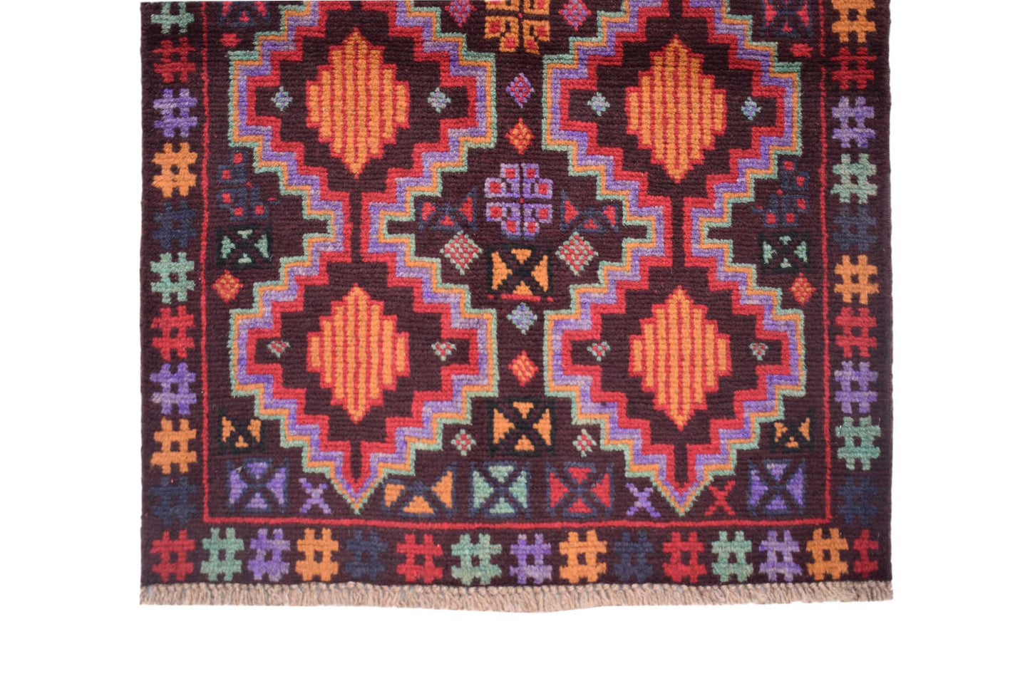 Handmade Afghan Pashm rug featuring geometric diamond patterns in vibrant colors on a dark background.