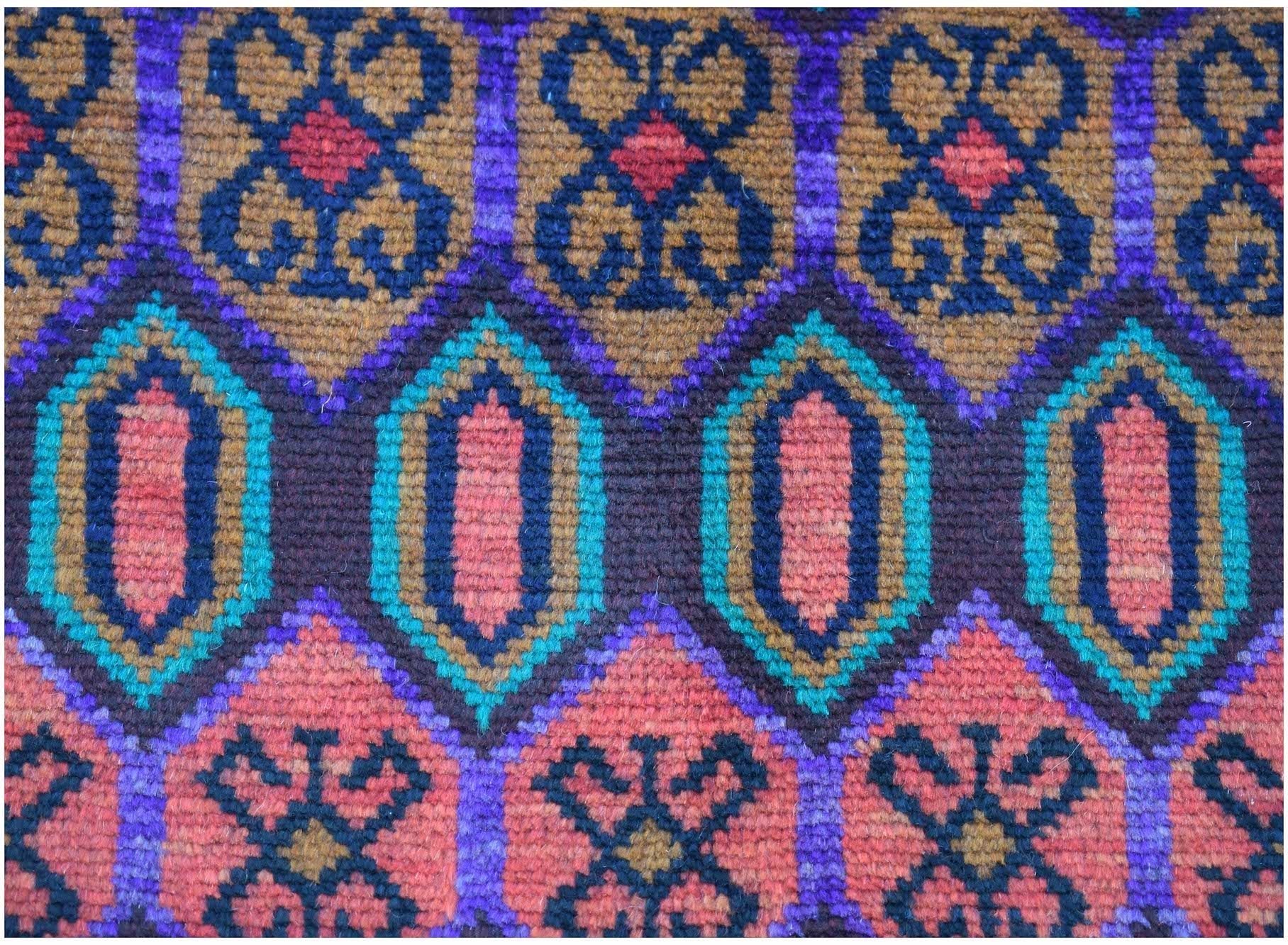 Handmade Afghan Pashm rug featuring a geometric pattern in shades of red, blue, and brown.